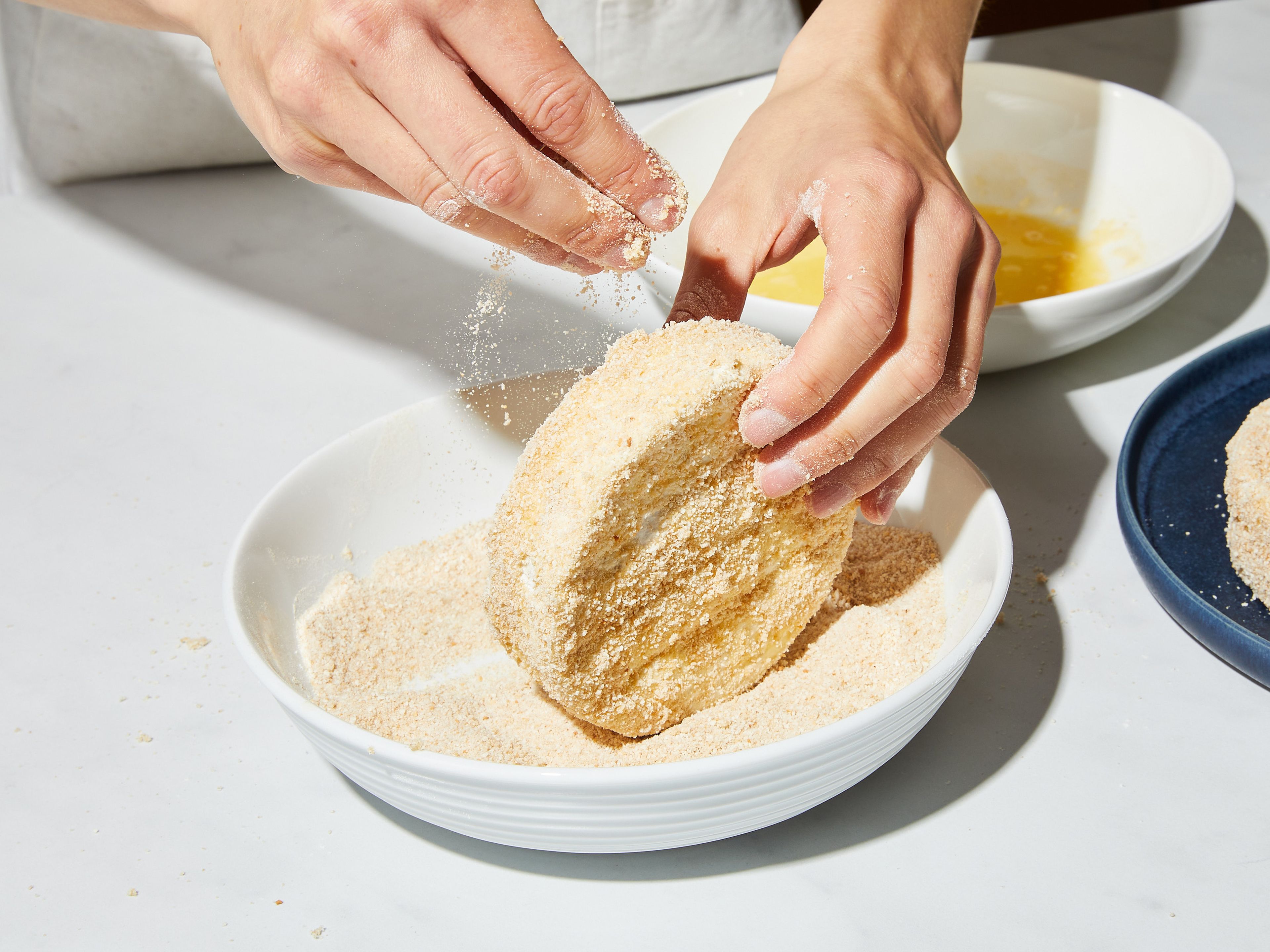 Preheat the oven to 100°C/200°F. Set up your breading station by adding flour, breadcrumbs, and egg to three separate, deep bowls. Beat the egg with a fork. Turn the cheese first in the flour, then in the egg, and lastly in breadcrumbs. Repeat the whole process with remaining cheese.