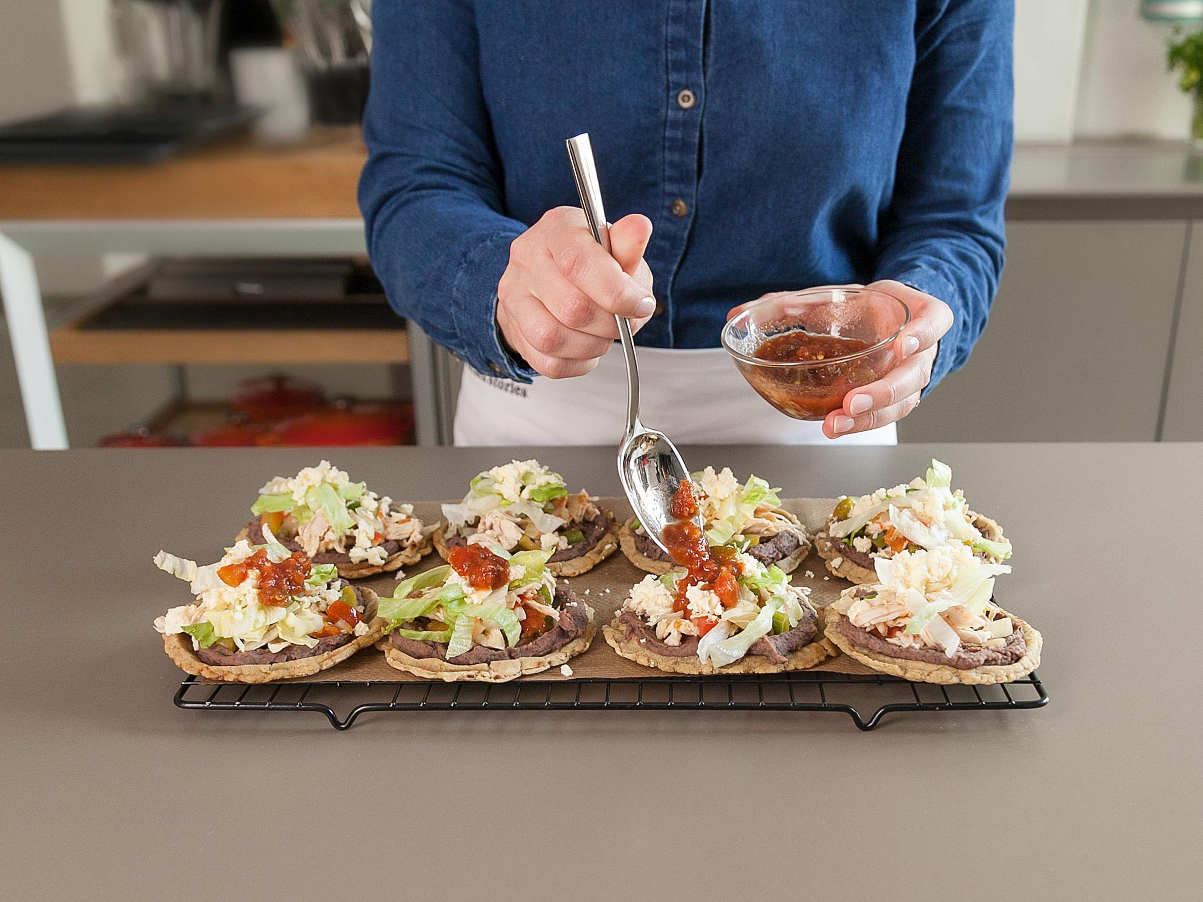 Top each sope with warm refried beans and the chicken and vegetable filling. Garnish with lettuce, grated queso fresco, and salsa to taste. Enjoy!