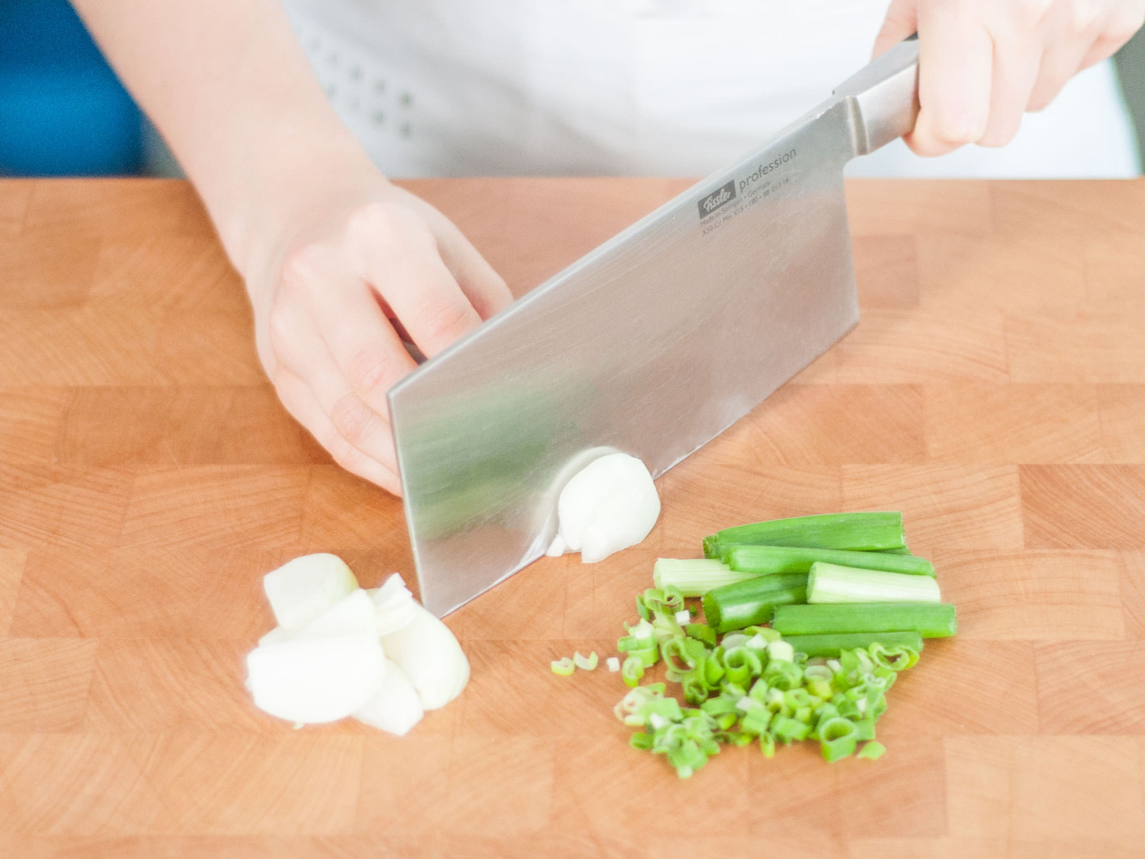 Halve the white tops of half of the scallions lengthwise, then roughly chop them; finely chop remaining scallions. Julienne the onion.