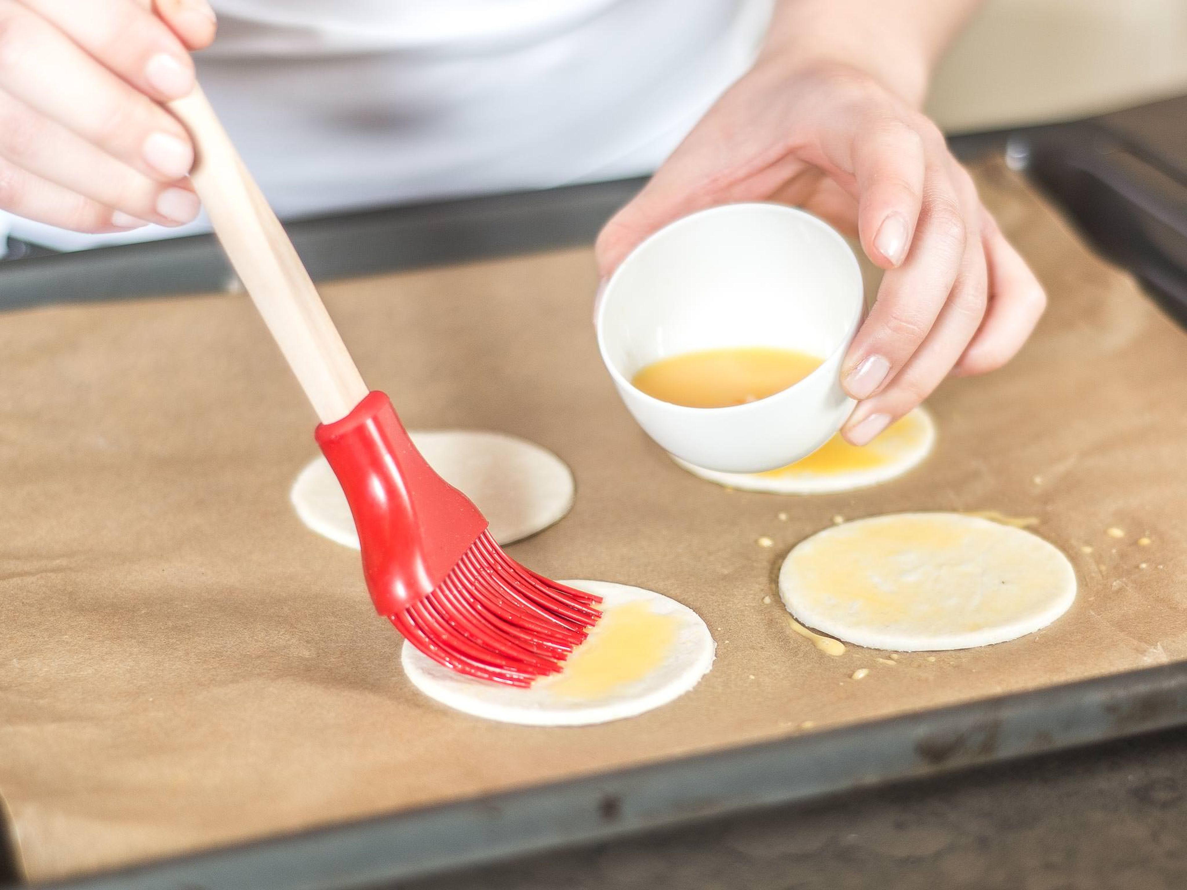 Whisk the egg yolk with water and brush the pastry with it. Bake until golden brown, according to package instructions. In a bowl, mix sugar with orange juice and zest, cinnamon, and honey.