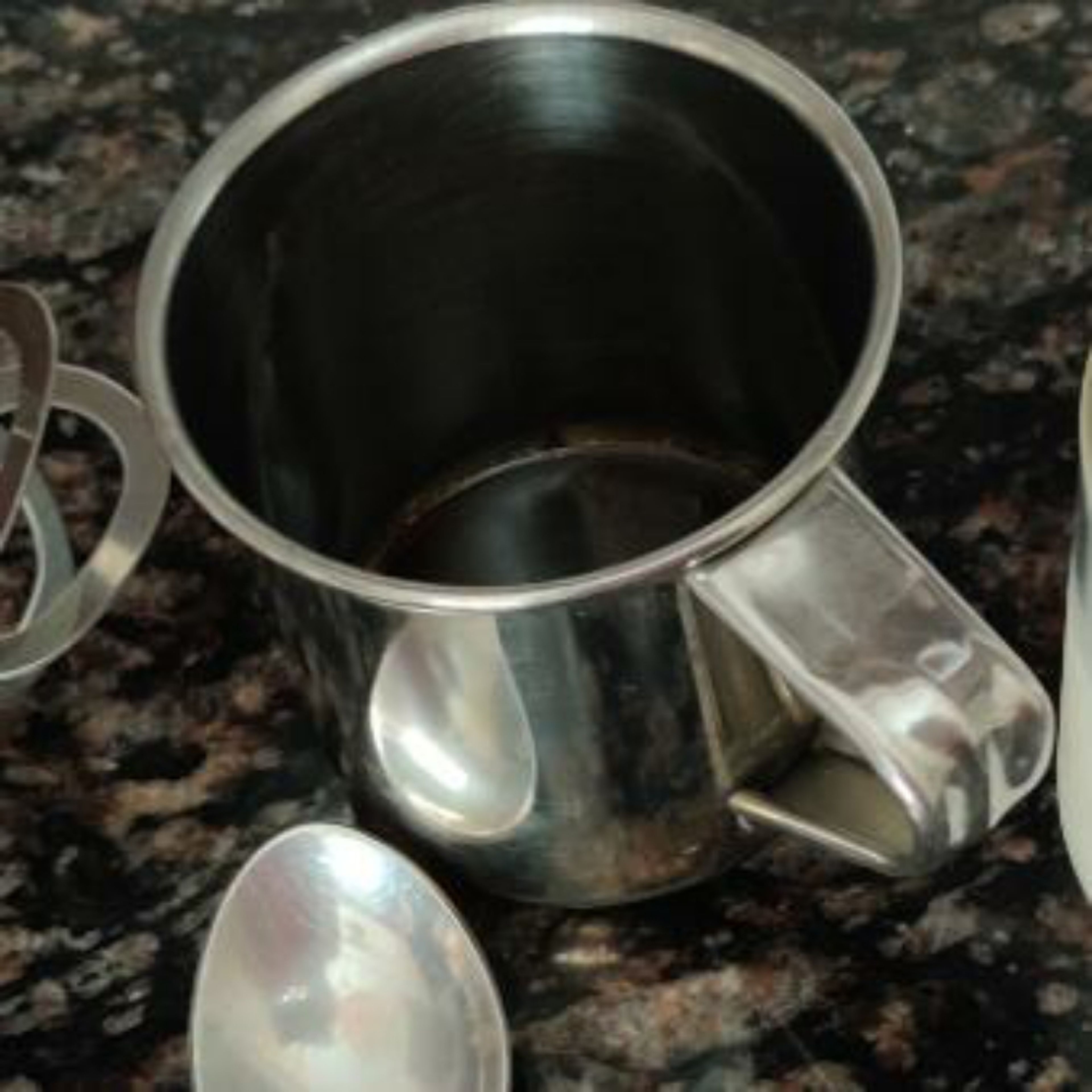 Add coffee powder, sugar and hot water in a mug.