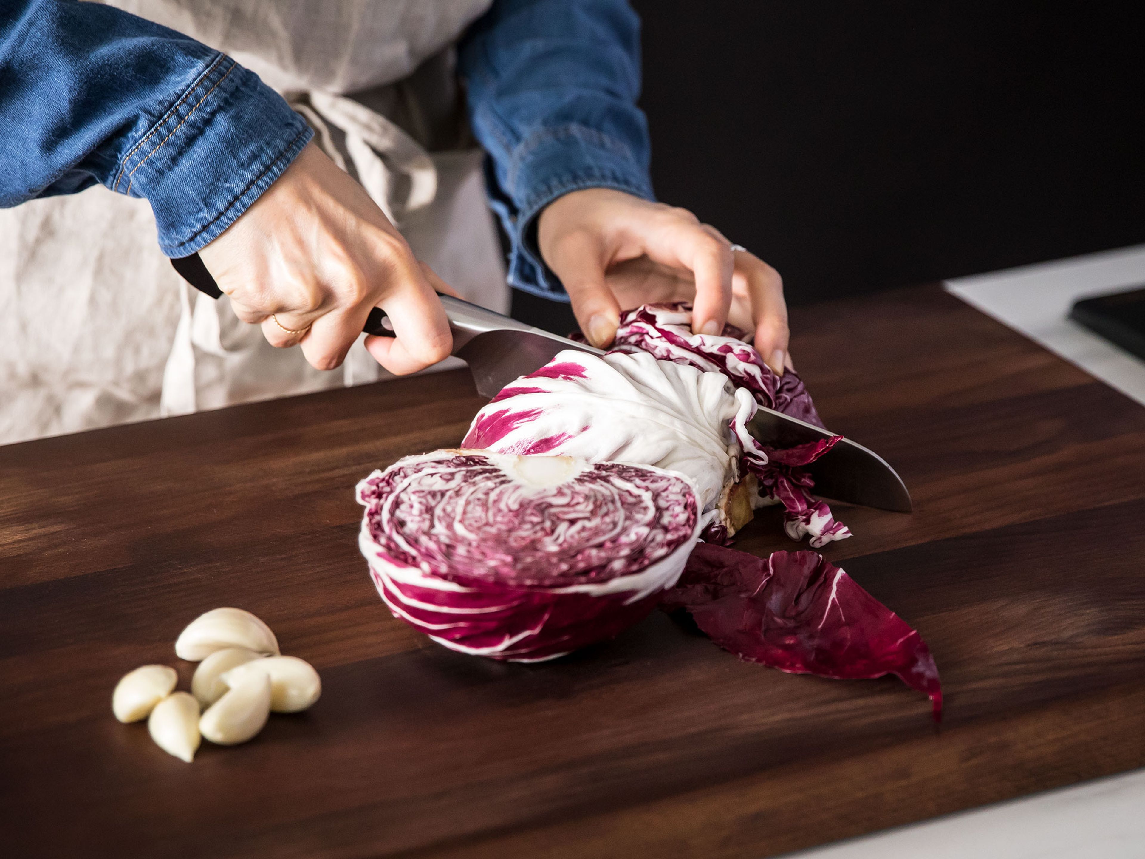 Season the chicken on both sides with salt and pepper.  Core the radicchio and cut into thin wedges. Peel the garlic cloves and crush them.
