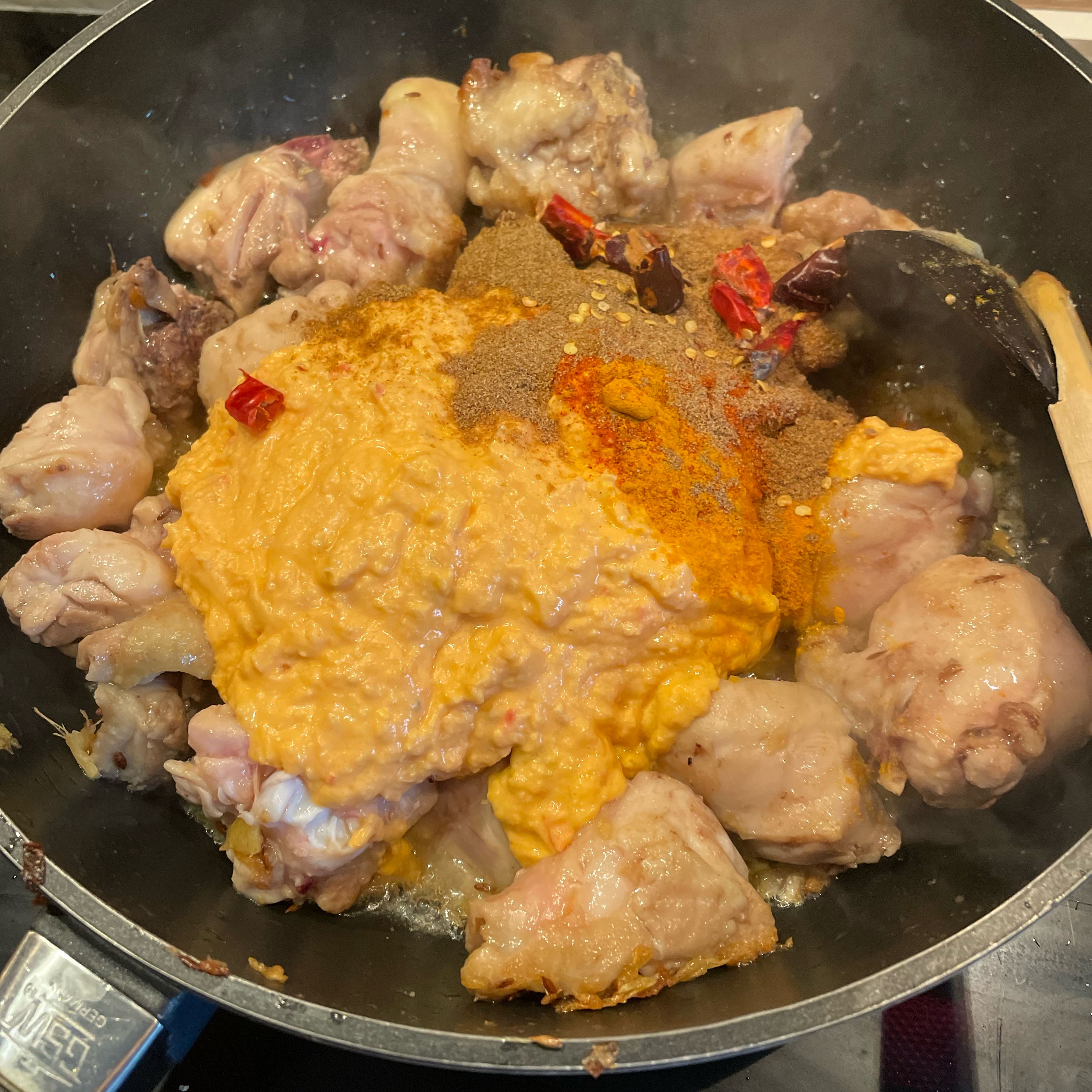 Add the curd mix and the ground spices, mix with the chicken and allow to simmer 2-3 minutes. Cover with a lid and cook on low to medium heat for 15 minutes.