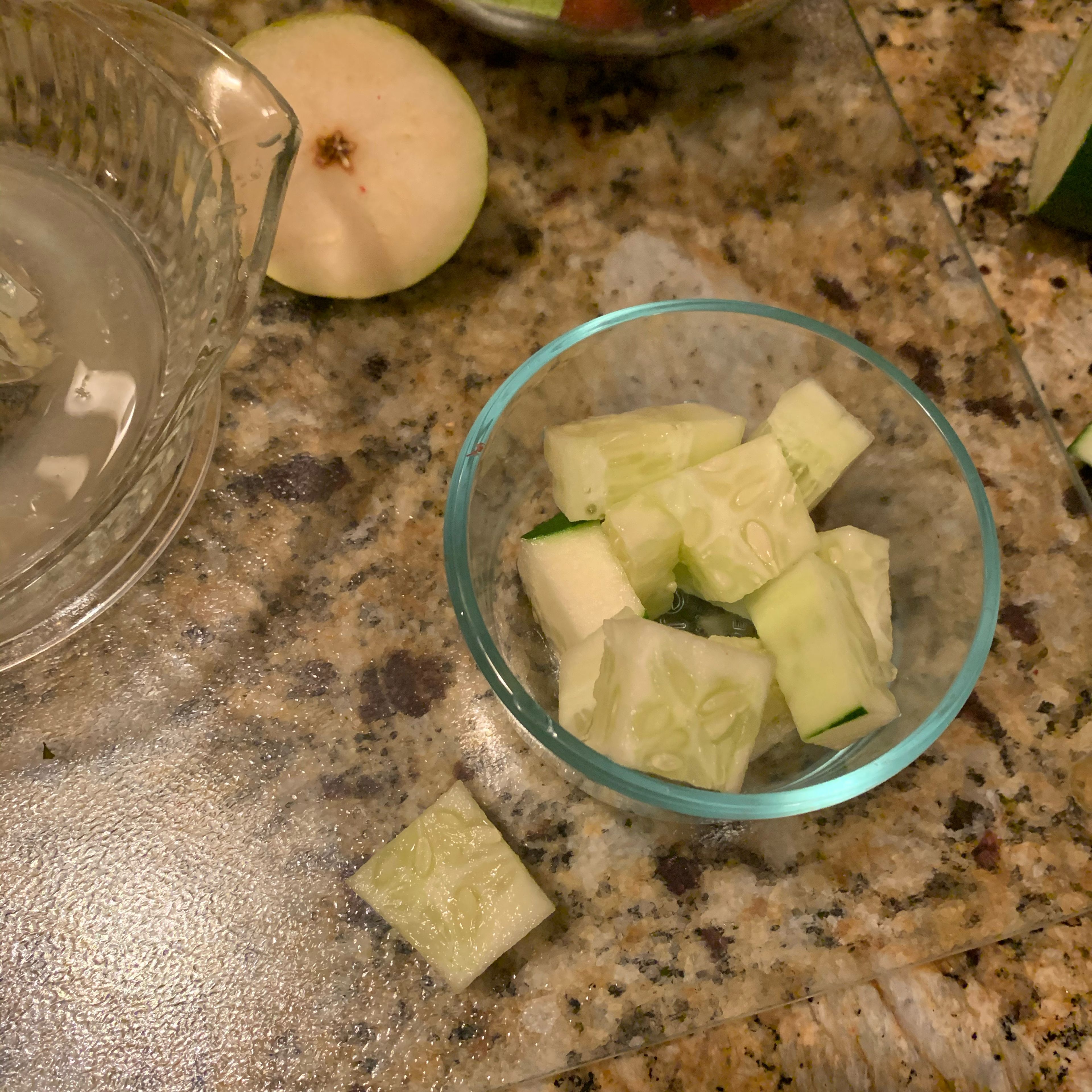 Cut up half of cucumber into small squares and add to fruit mixture.