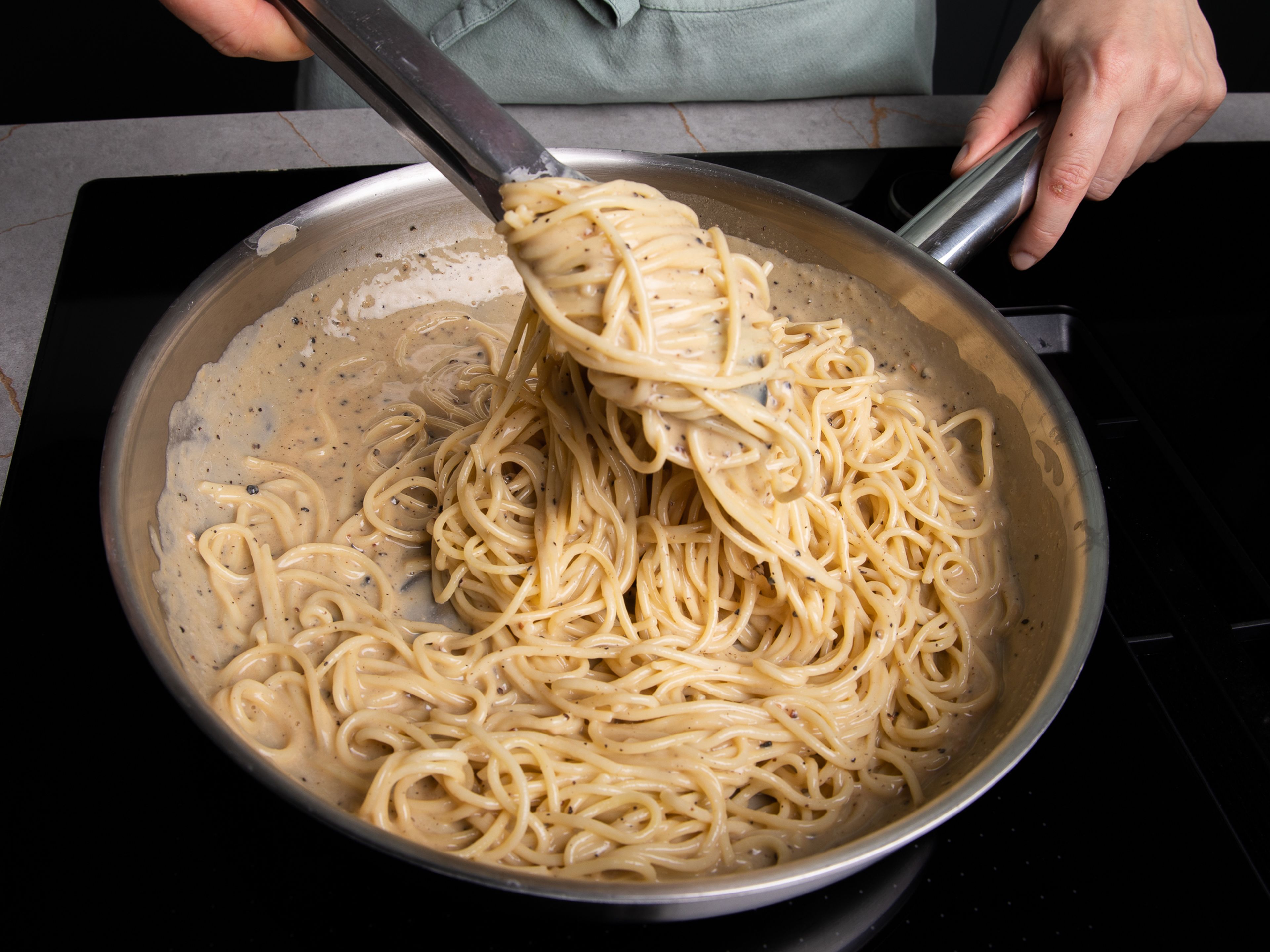 Turn off the heat, add drained pasta and mix fast until the sauce is creamy and glossy. If necessary, add a spoonful of pasta water. Serve with the remaining crushed black pepper and drizzle with a little more olive oil if desired.