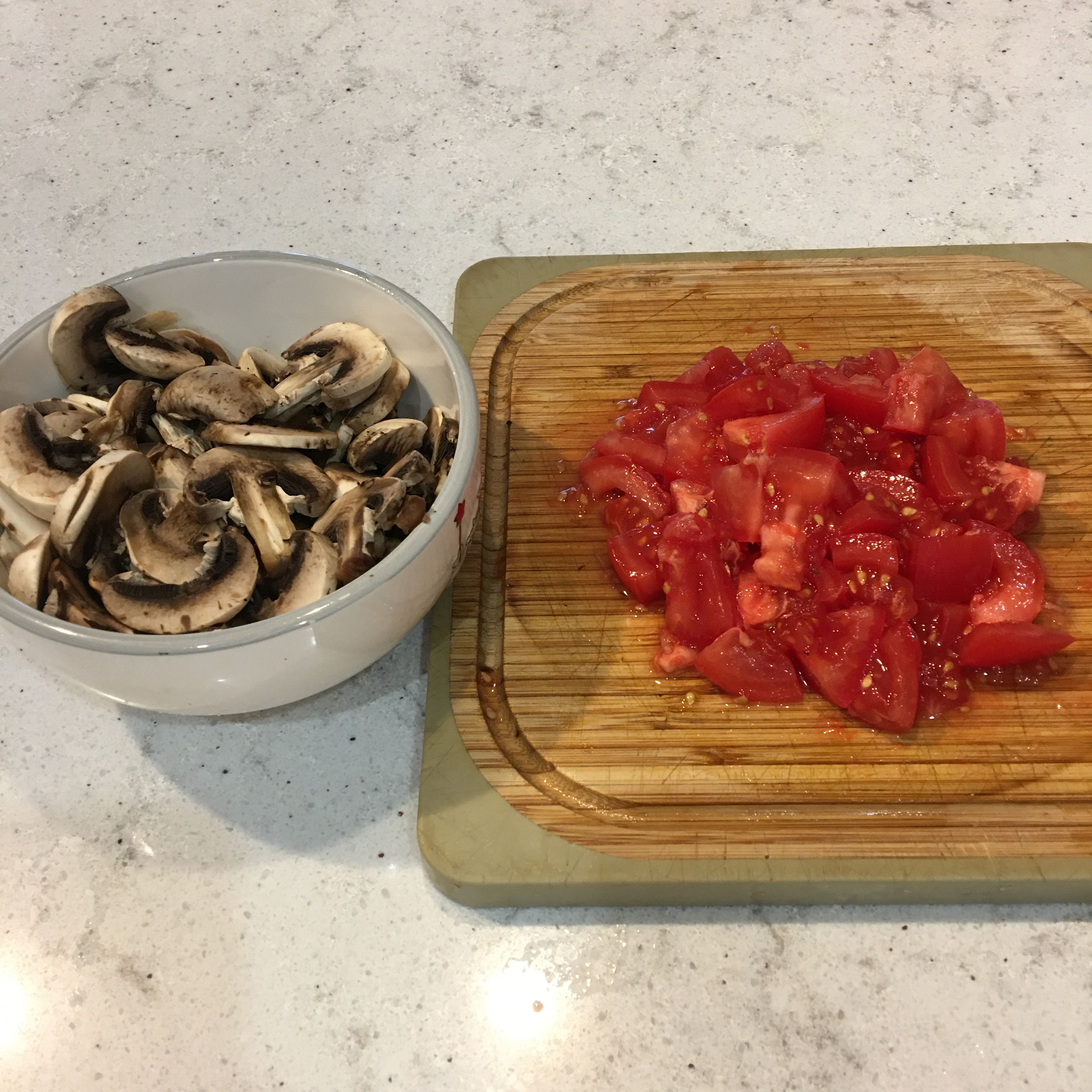 In the meantime wash and clean the tomatoes and mushrooms, then chop them.