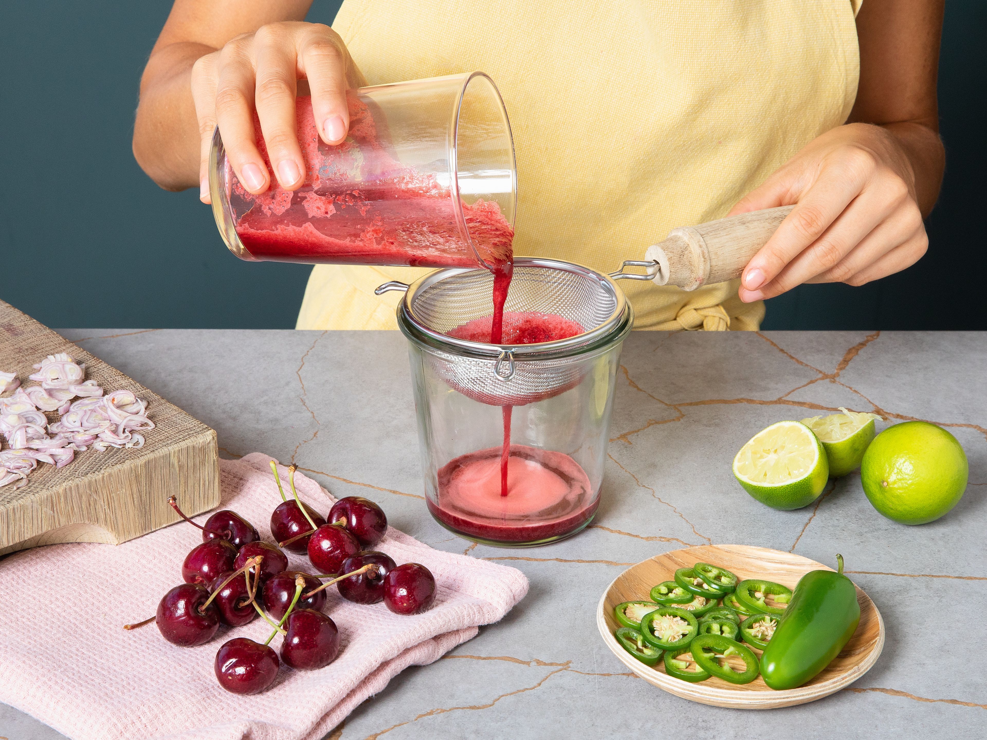 Cut jalapeños into thin slices and shallot into fine rings. Halve and pit the cherries. Squeeze juice from limes and mix together with cherries, a third of the jalapeños, and soy sauce, using an immersion blender. Strain vinaigrette. Meanwhile, cut fish into thin slices.