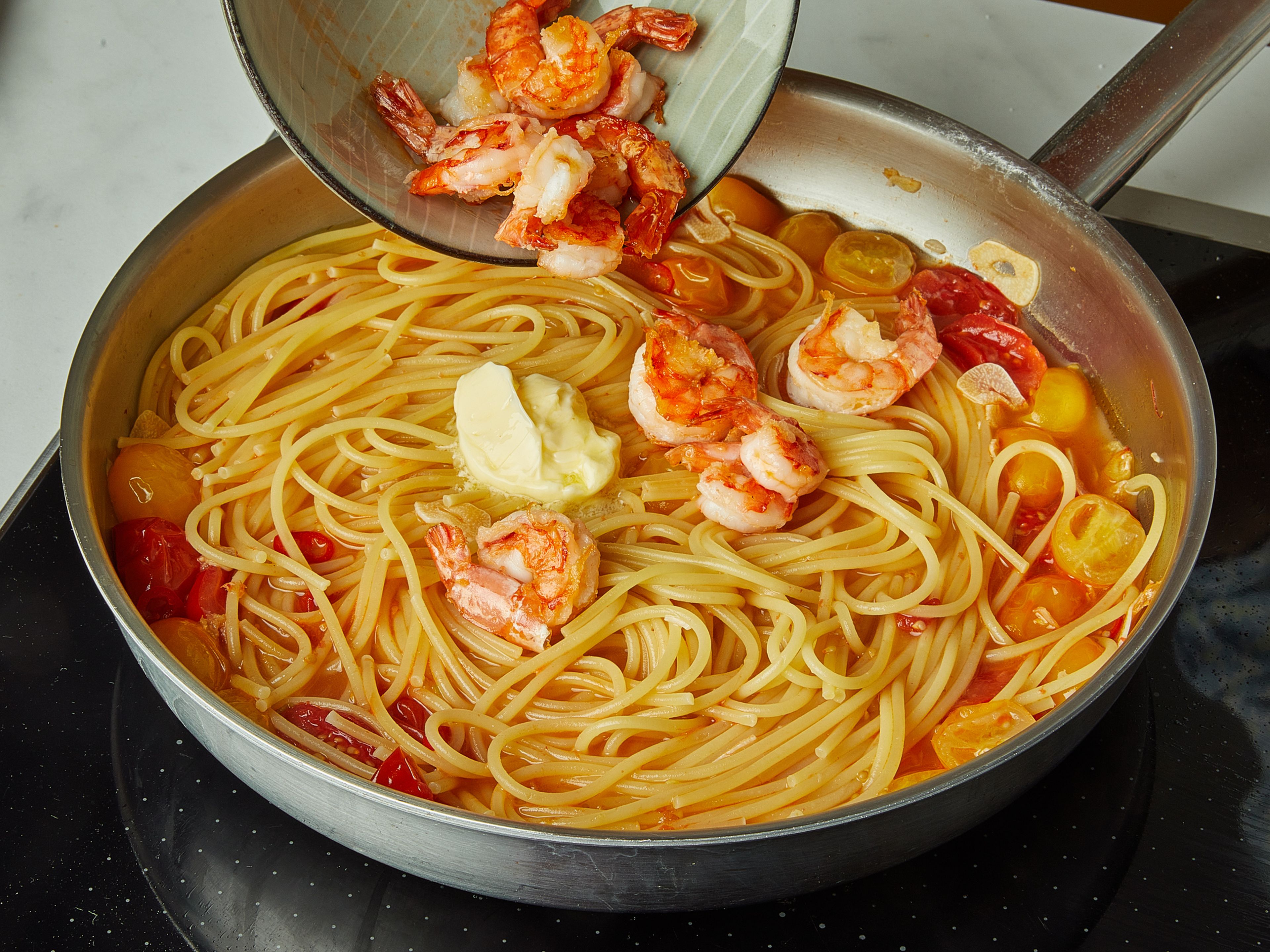 Remove the lid, add the butter, and let simmer for another 5 min., until the sauce is thick and glossy. Finally, add shrimp and warm through briefly. Arrange pasta on plates and garnish with basil leaves.