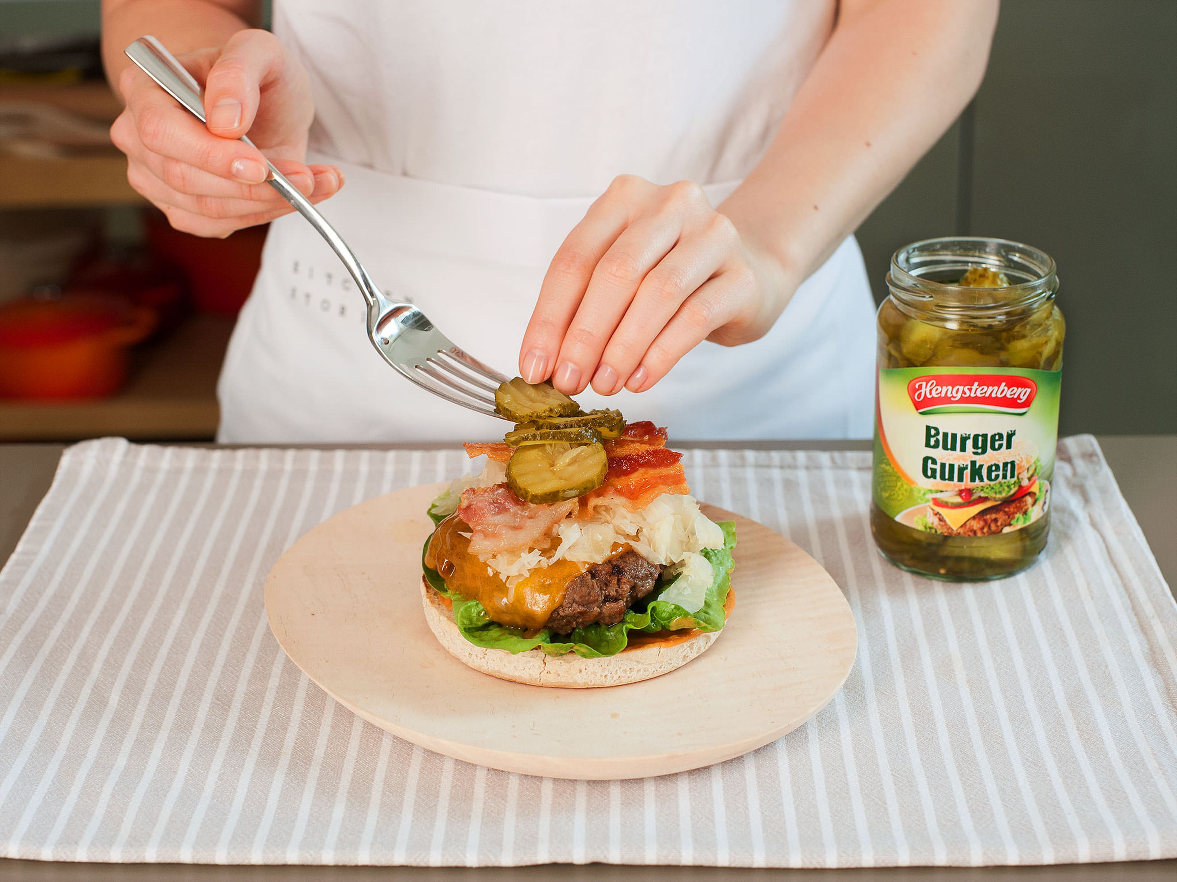 In the meantime, wash and dry lettuce. Heat a large, clean frying pan over medium heat, then add very little vegetable oil and toast burger buns for approx. 60 – 90 sec. per side. Mix together ketchup and mustard; spread an even layer over bottom burger bun. Assemble burger by layering lettuce, burger patty, sauerkraut, bacon, and pickles on top. Finish with some more sauce and top half of burger bun. Enjoy!