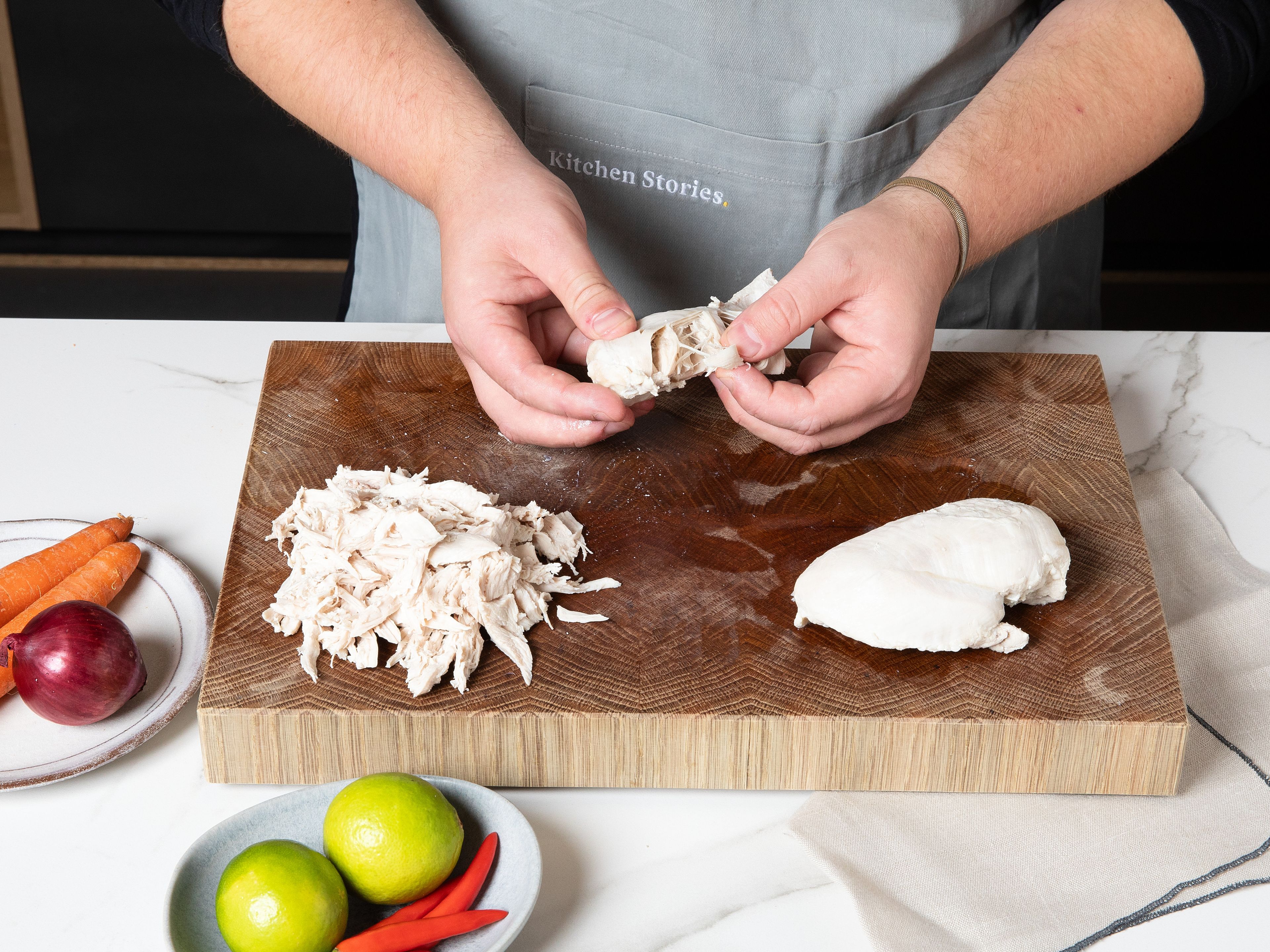 Bring lightly salted water to simmer. Add whole chicken breasts and let poach for approx. 15 min. Remove from the water, let cool, and shred into fine strips by hand or using a fork.