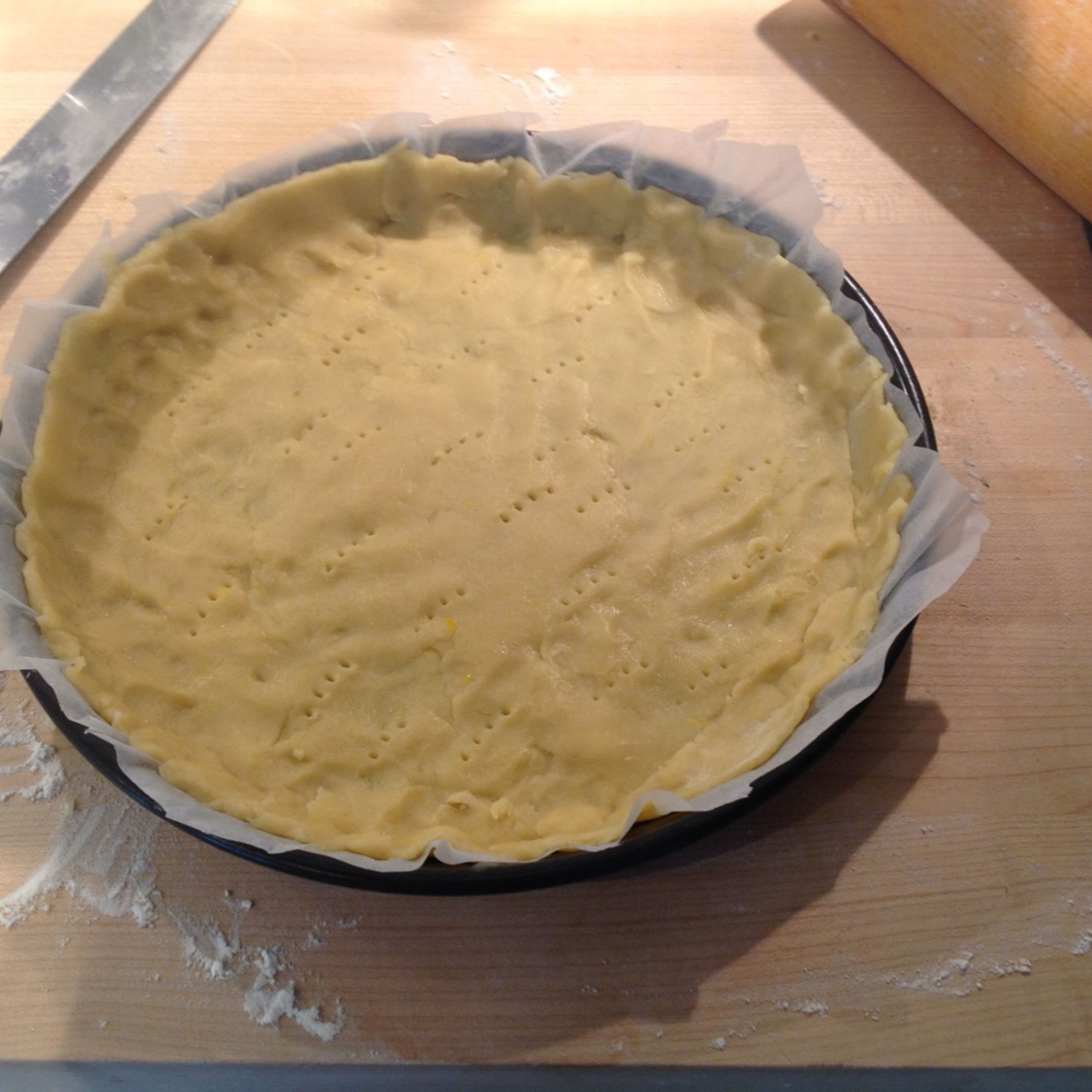 Put dough in a pie dish lined with parchment paper. Pierce dough all over with a fork.