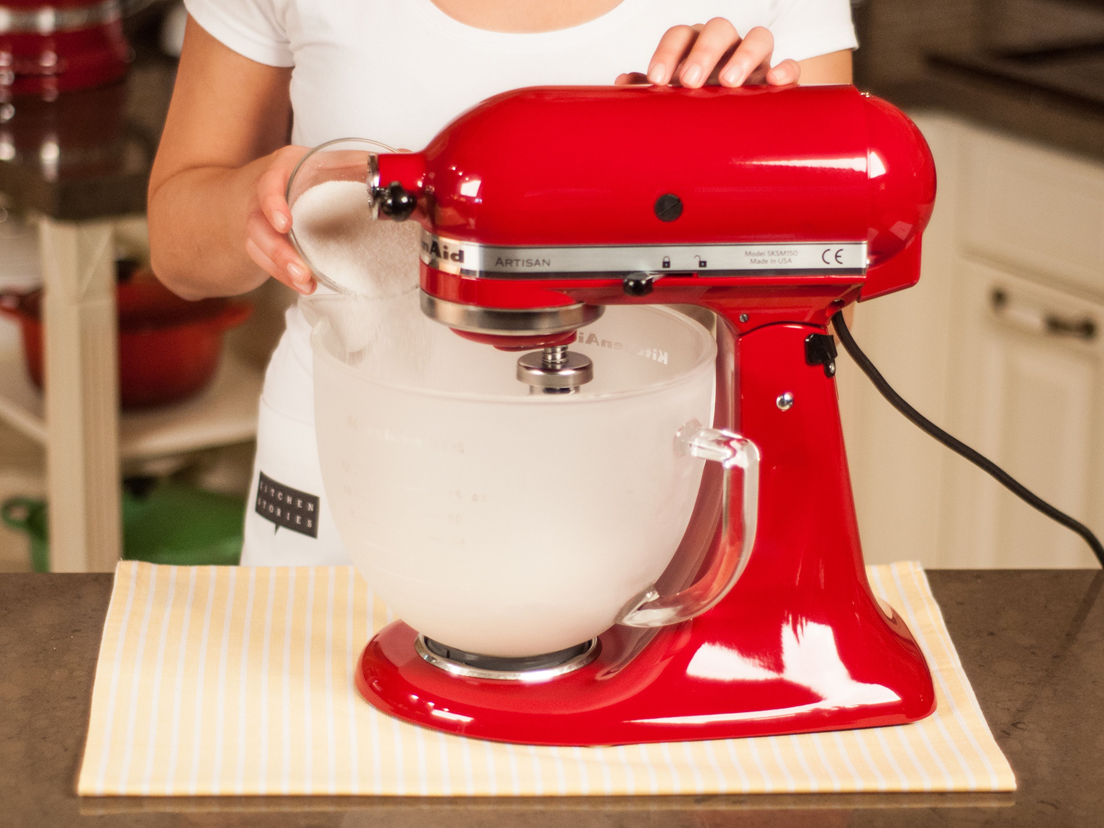 With a standing mixer or a hand mixer beat egg whites until stiff. As soon as they begin to foam, gradually add sugar. The bowl and the beater should be free from any kind of grease to create the desired consistency.