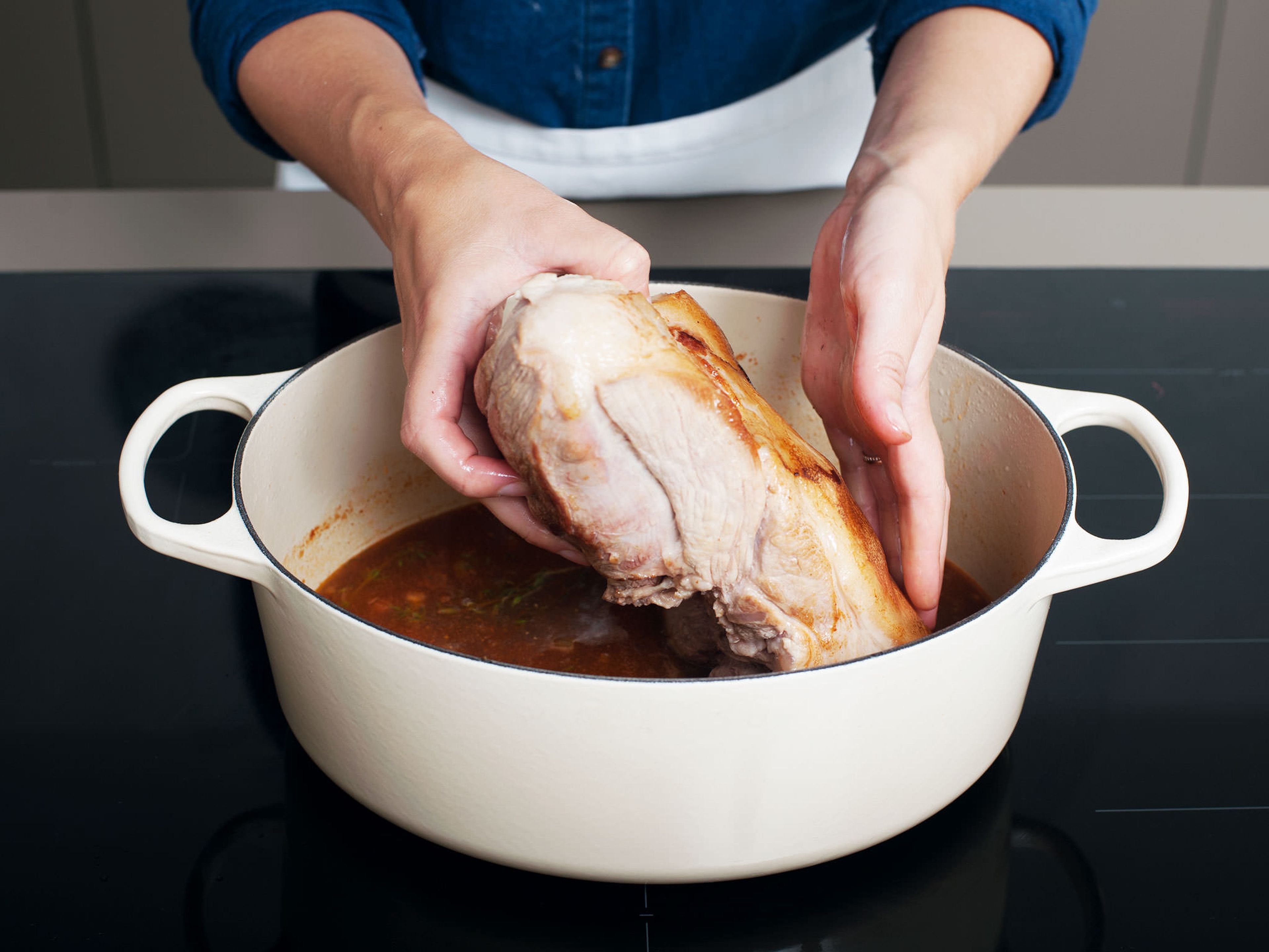 Return pork to pot, cover, and transfer to oven. Cook for approx. 3 hrs. at 150°C/300°F, then uncover pot and continue to cook for approx. 1 hr., or until the meat is fork tender. Transfer pork to cutting board and tent with aluminum foil to keep warm.