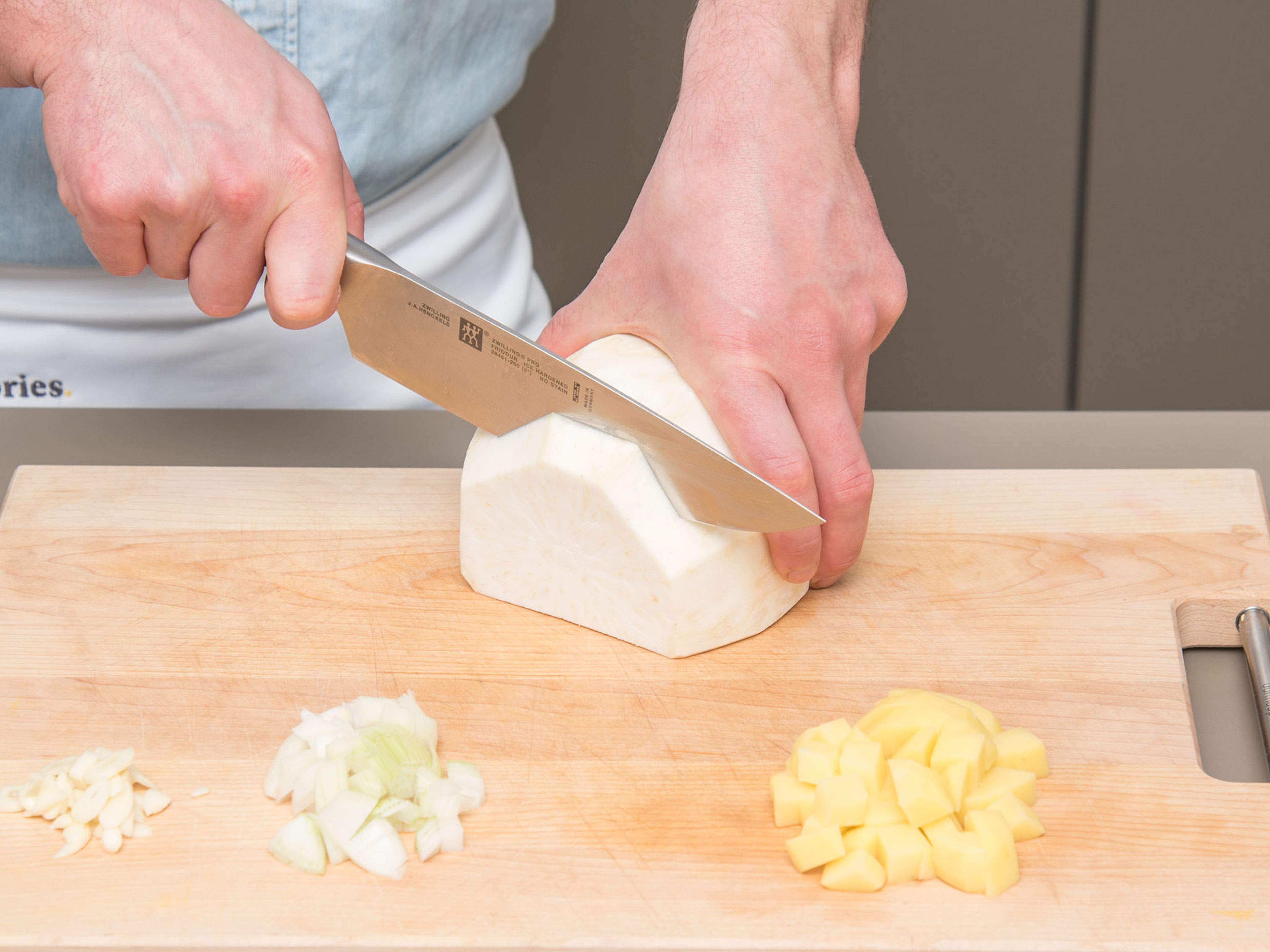 Peel and roughly chop onion, garlic, potatoes, and celery root.