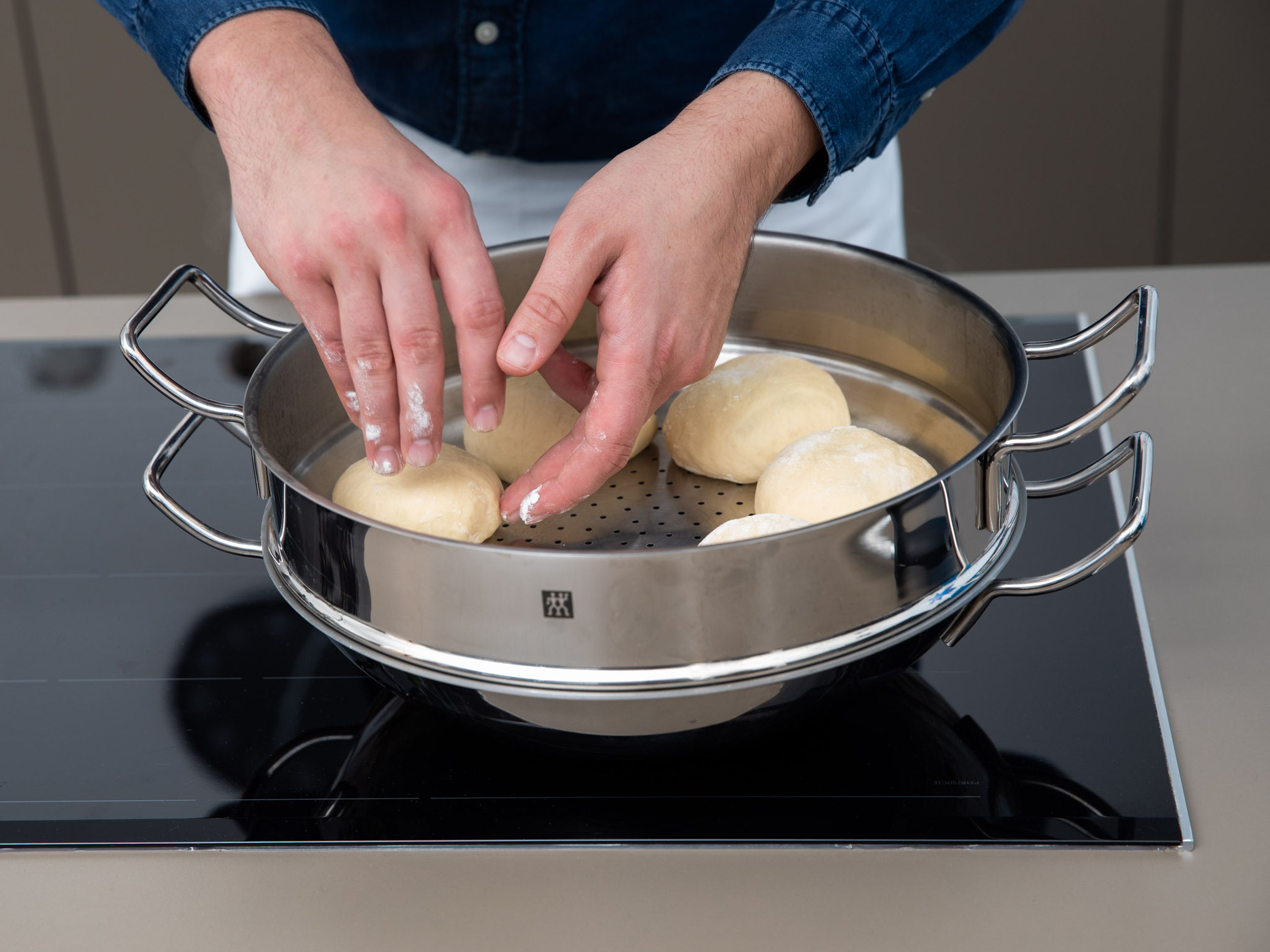 In a pot, bring water to a boil. Transfer the yeast dumplings to a sieve inside the pot, but make sure that sieve and water only touch slightly. Cover and let the dumplings steam over medium heat for approx. 12 – 15 min.