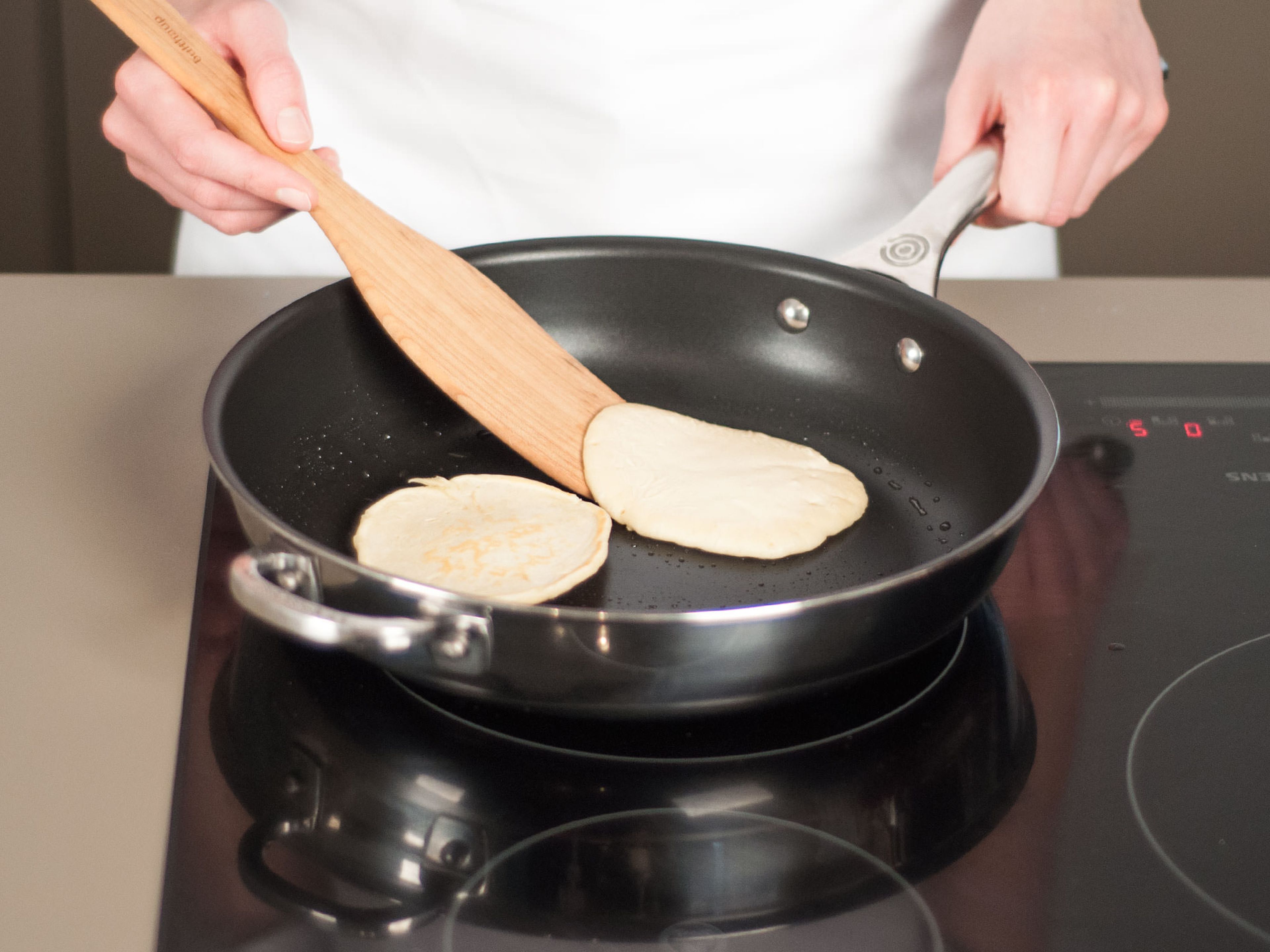 Brush a large, non-stick frying pan with some of the remaining melted butter over medium-low heat. Drop batter into the hot pan to form small rounds. Wait for approx. 2 – 3 min. until the sides set and small bubbles form on top of the blini rounds. Flip to cook for approx. 2 – 3 min. on the other side. Place on a serving plate.