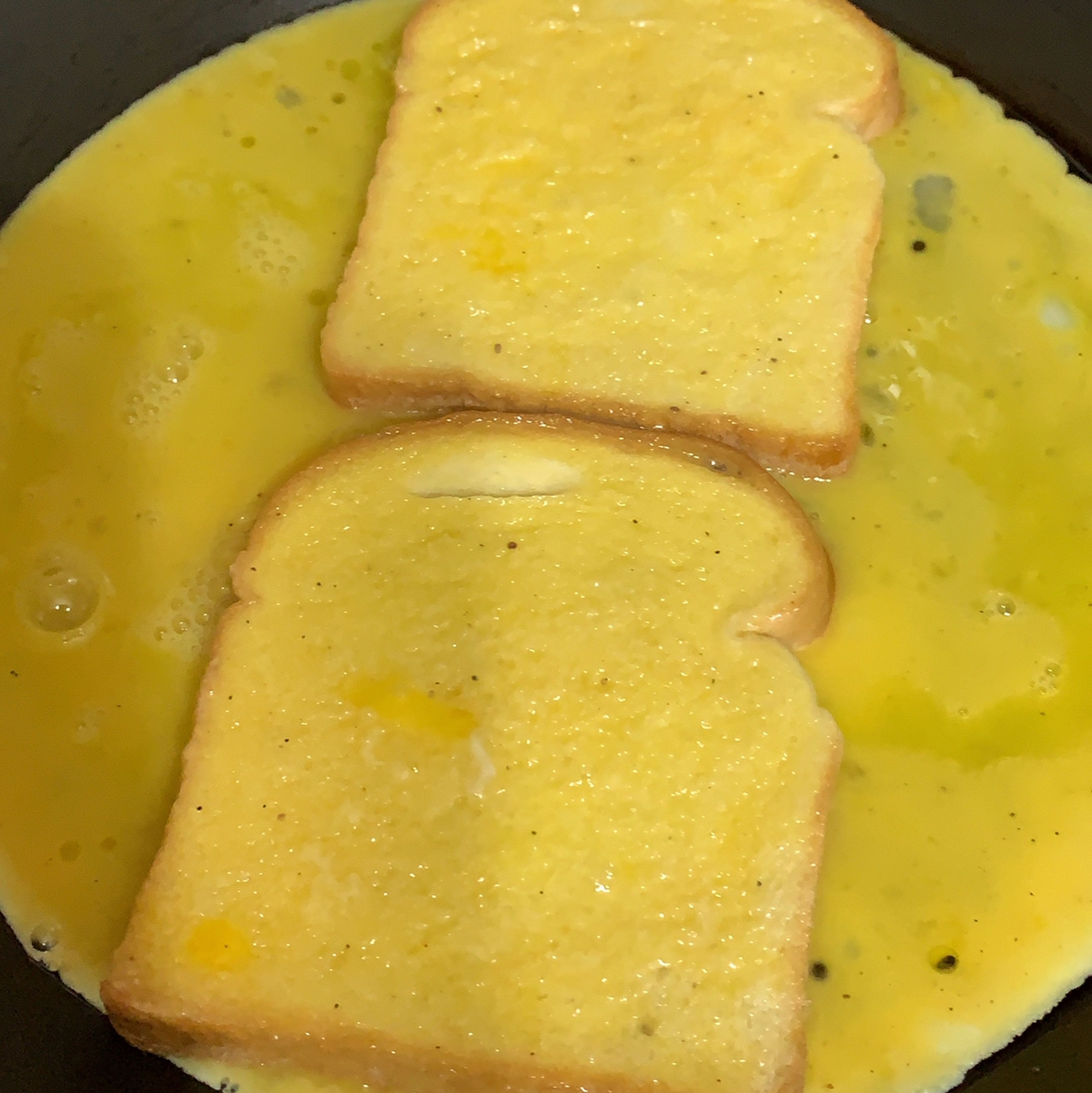 As the pan heats up, lower the heat and pour in the eggs and then put the toast above the eggs vertically as seen in the pic attached. Quickly dip the toast on both sides so they can have some of the eggs and let it rest. 