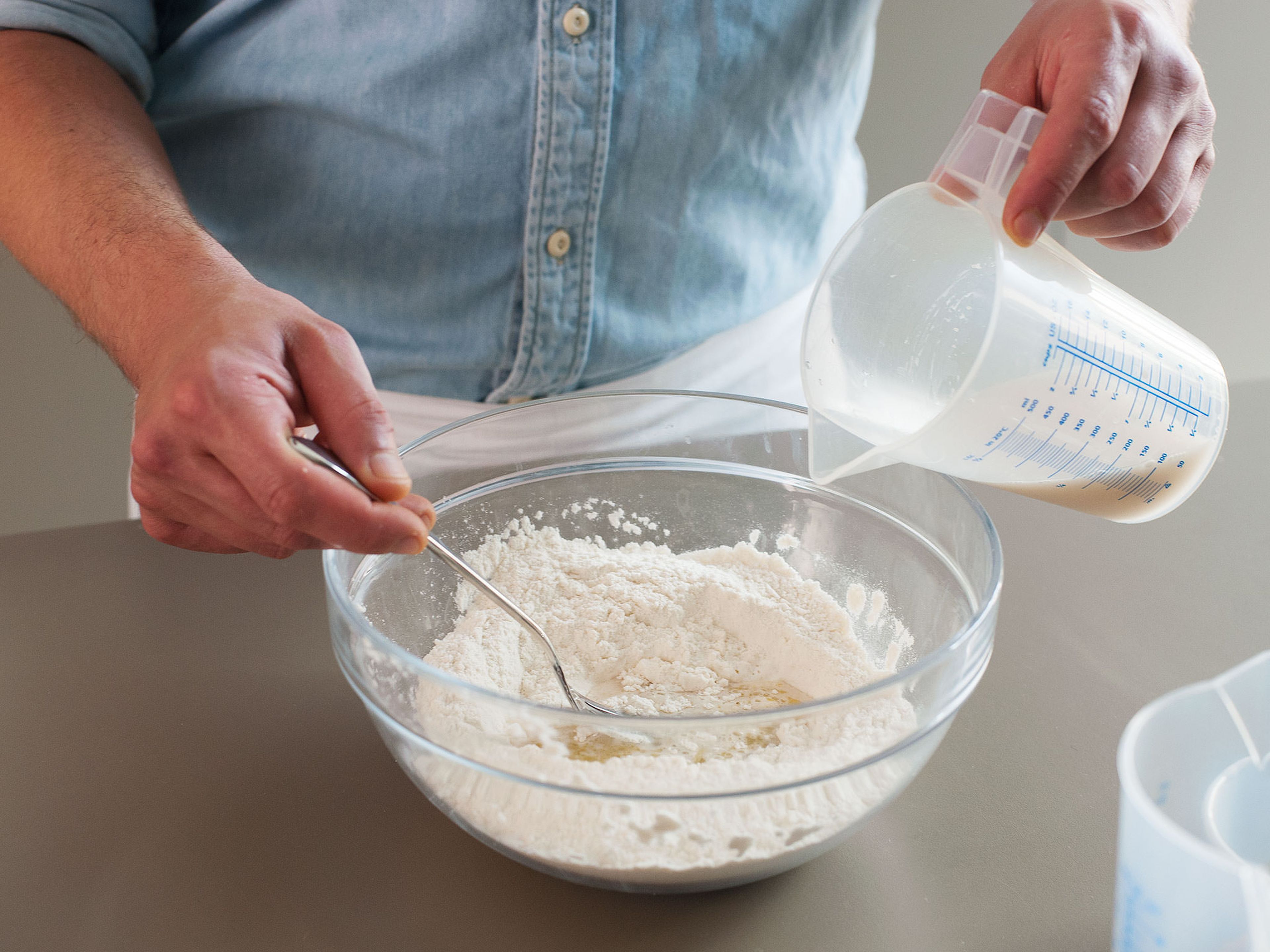 In a large mixing bowl, mix together flour and salt. Then add olive oil and water mixture to center of the flour and mix together until well incorporated.