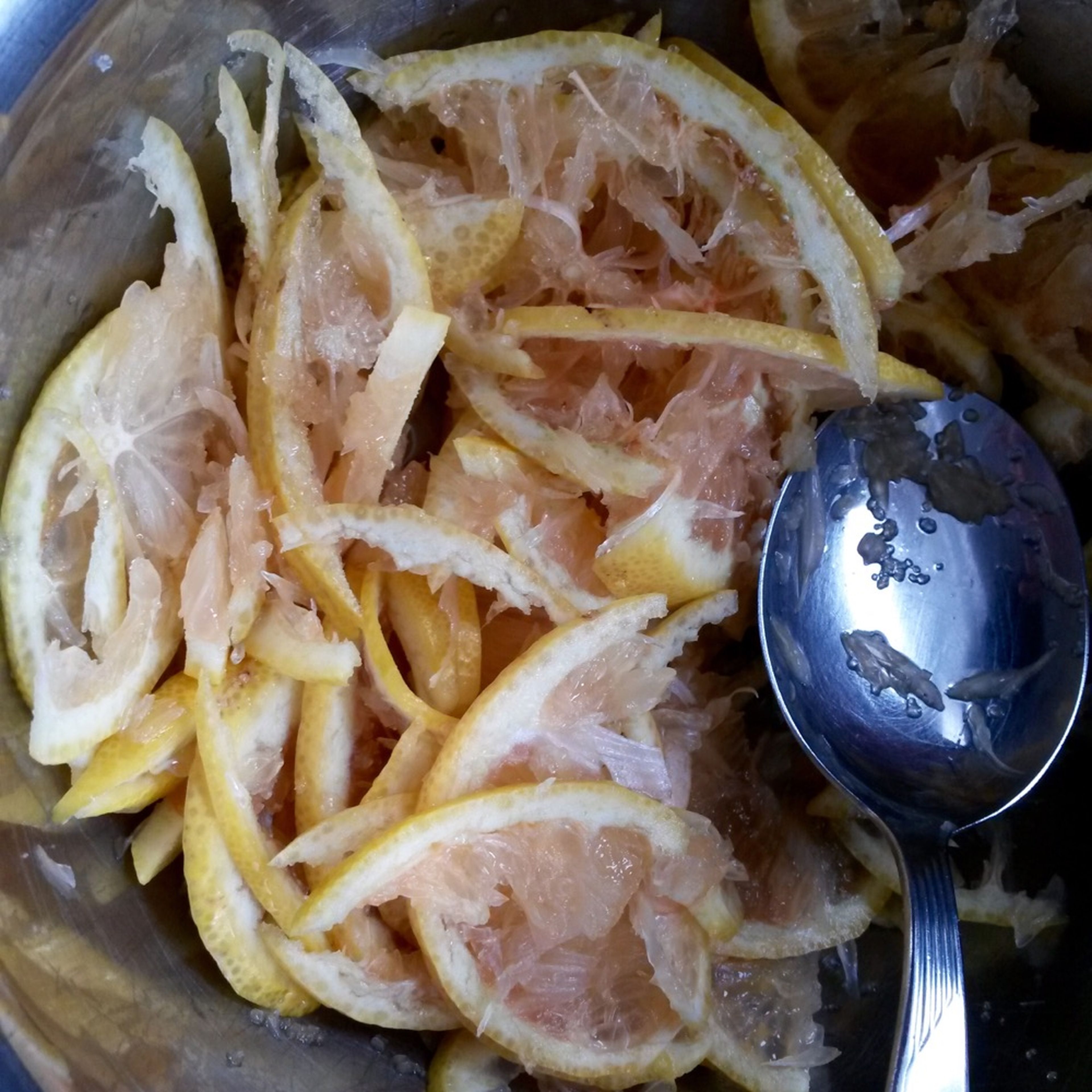 Finely slice lemon and combine with sugar in a bowl.