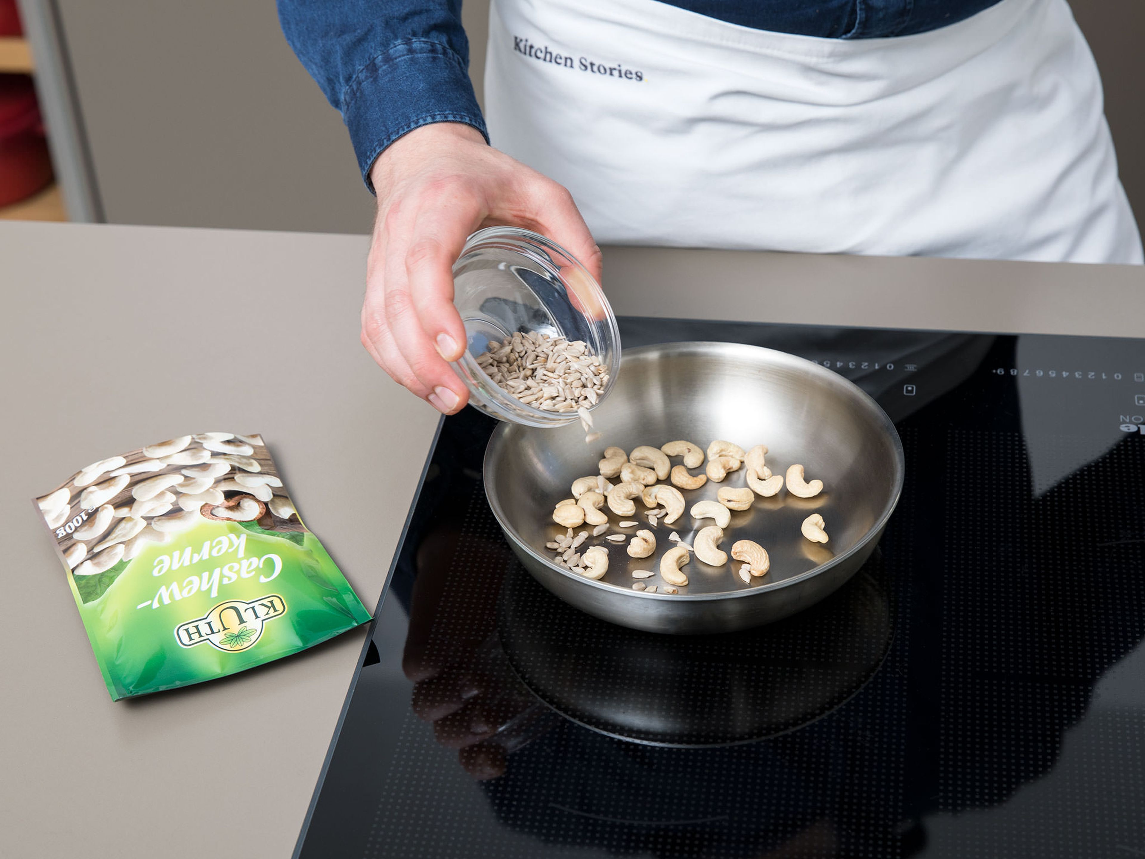 Heat a frying pan over medium-low heat. Toast cashews and sunflower seeds until fragrant and lightly browned, tossing often to avoid burning.