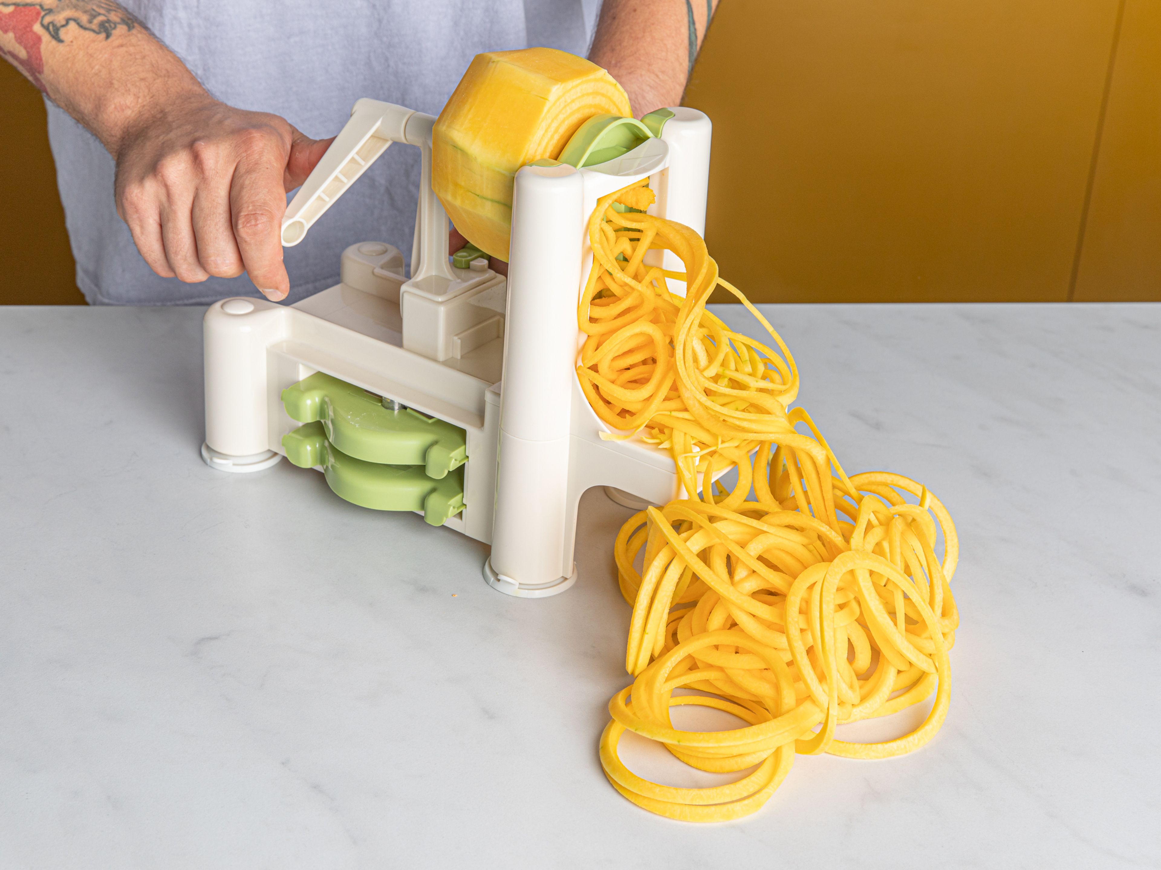 Peel squash and spiralize into noodles.