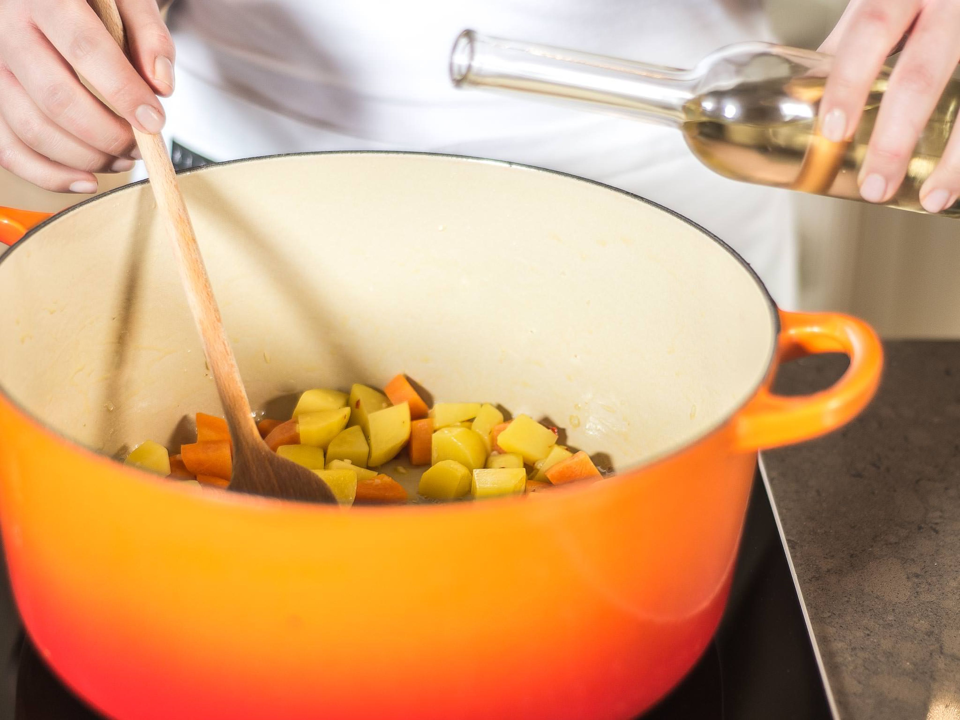 Sauté garlic, chili, onion, potatoes, leek, and carrot in olive oil over medium heat. Deglaze pan with white balsamic vinegar.