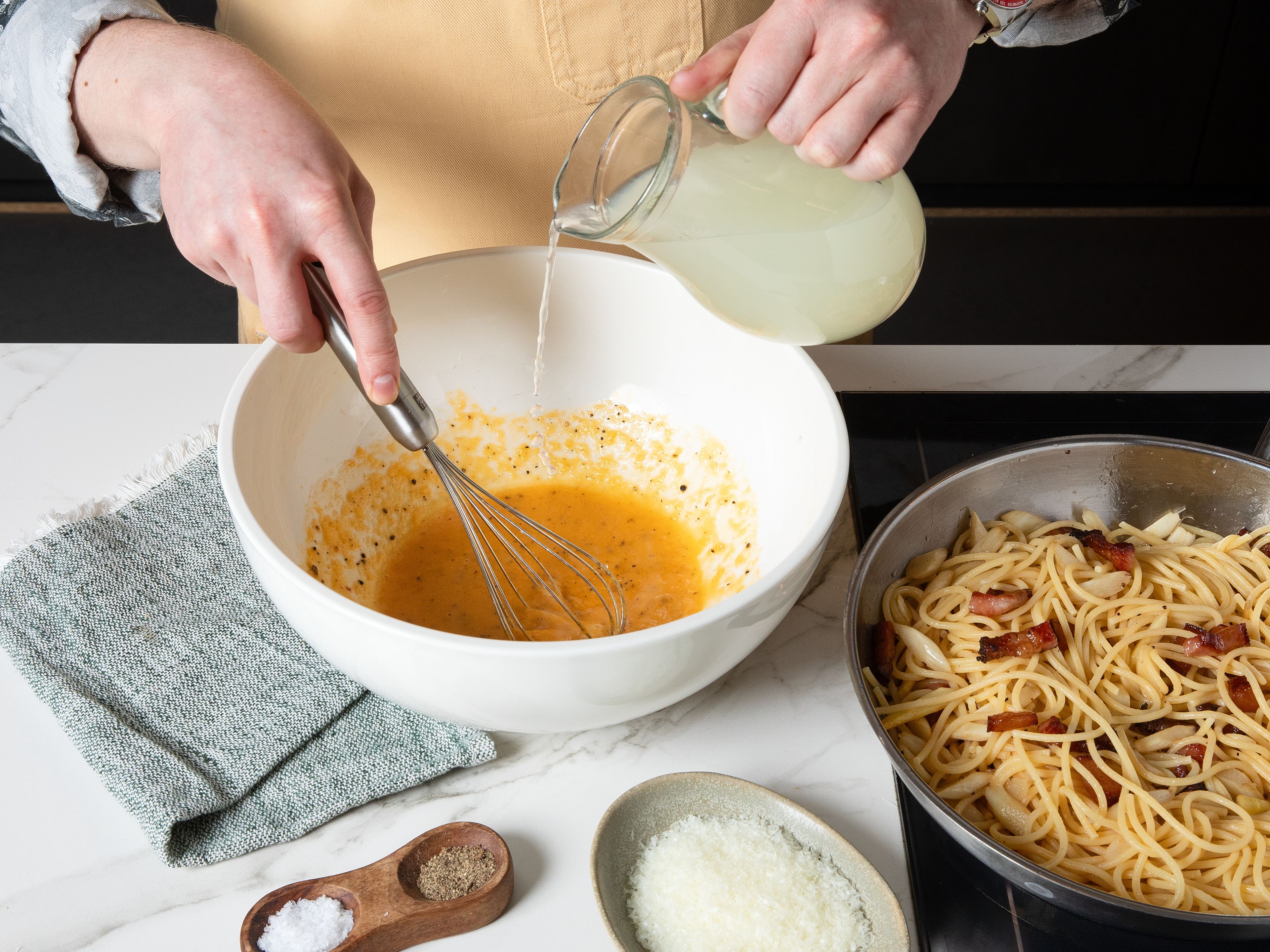 Drain spaghetti and reserve some pasta water. Take frying pan with guanciale and white asparagus off heat, add spaghetti and toss to combine. In a large bowl, slowly whisk pasta water into egg mixture to create a creamy sauce, adding more pasta water if sauce is too thick. Finally, add contents of frying pan to a large bowl with sauce and mix to combine everything together. Serve with more Pecorino on top.