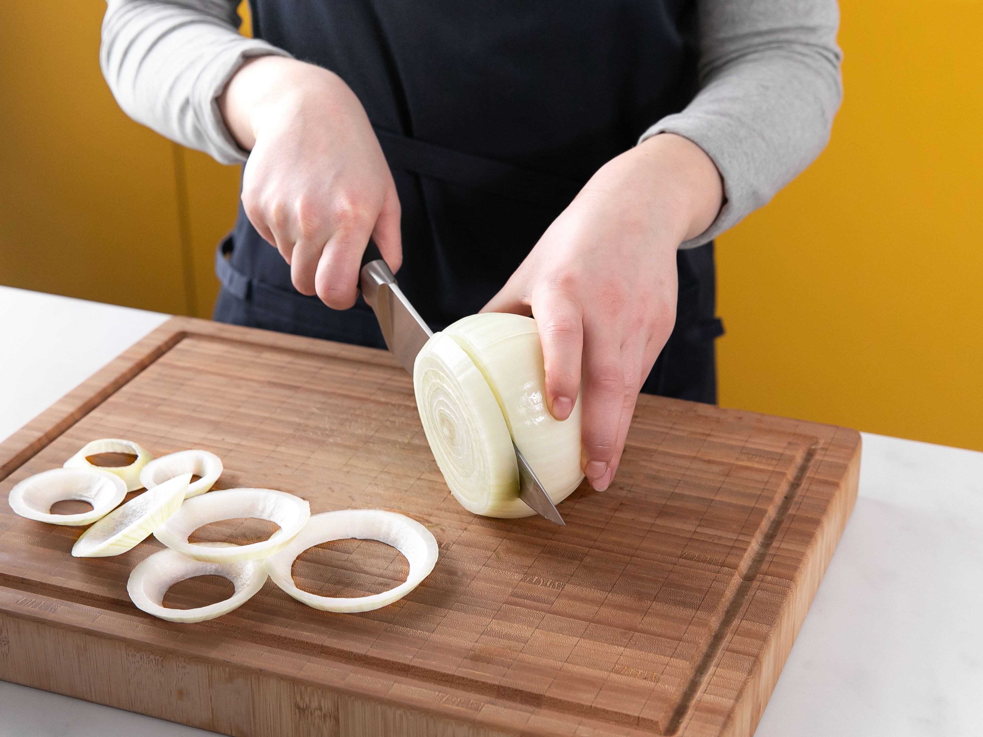 Peel onion and slice into ½ cm/¼ in. thick rings. Stir flour, baking powder, and salt together in a bowl. Add the milk and egg to a separate bowl and whisk to combine. Pour breadcrumbs evenly into a rimmed plate.