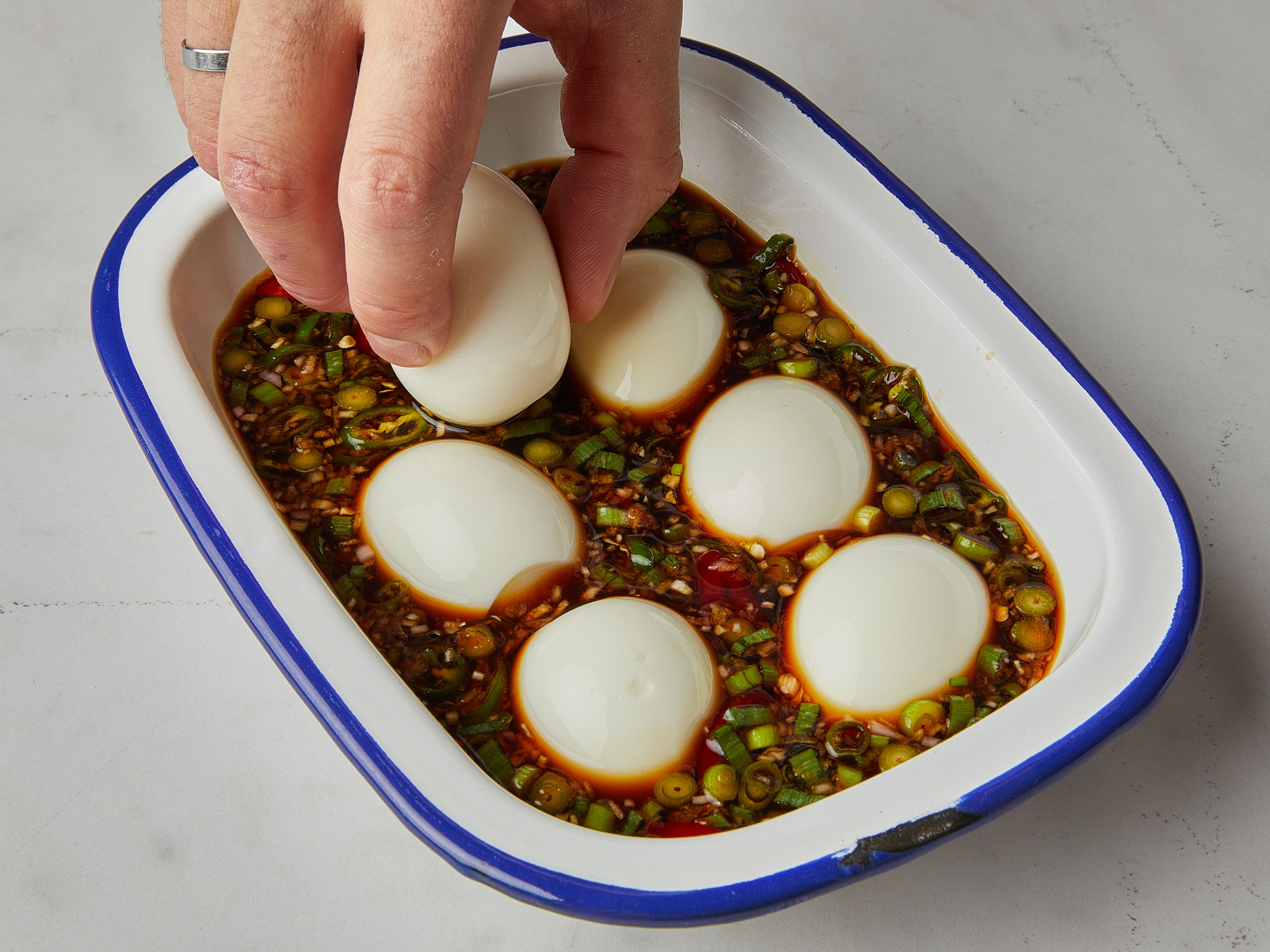 Once the eggs have cooled, peel and add to the marinade. Make sure the eggs are completely soaked in the marinade. Cover with plastic wrap and store in the refrigerator for at least 6 hours, or ideally overnight. Flip once halfway through so the eggs will be marinated evenly on all sides.