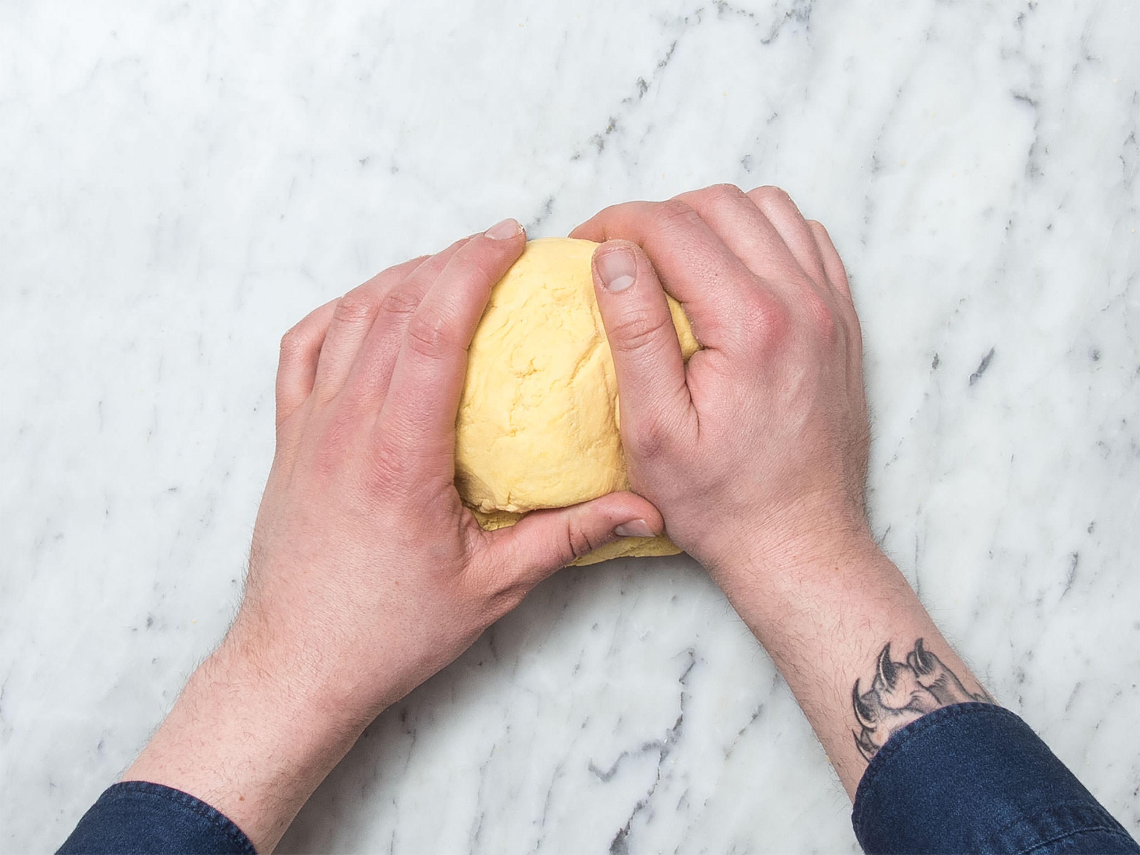 Add cornflour, most of the flour, two-thirds of the salt, olive oil, and water to a large bowl. Beat with a hand mixer with dough hook until a smooth dough forms. Knead the dough with your hands for approx. 5 min. more. Add more water if the dough crumbles too easily.