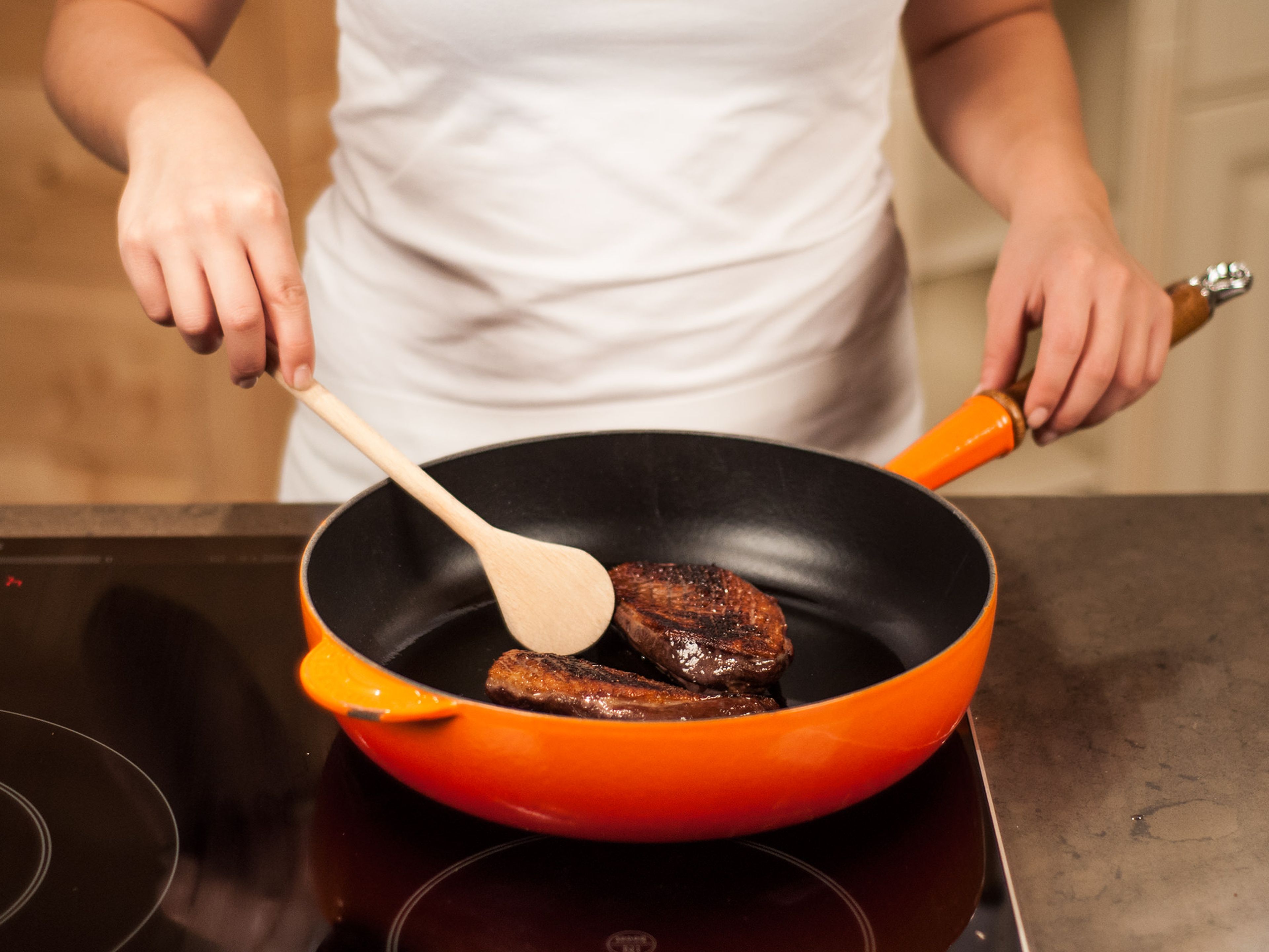 Remove duck breasts from the oven. Add some oil to a large frying pan and crisp duck in hot oil on both sides, starting with the skin-side down. Fry for 1 – 2 min. on each side until cooked to the desired degree.