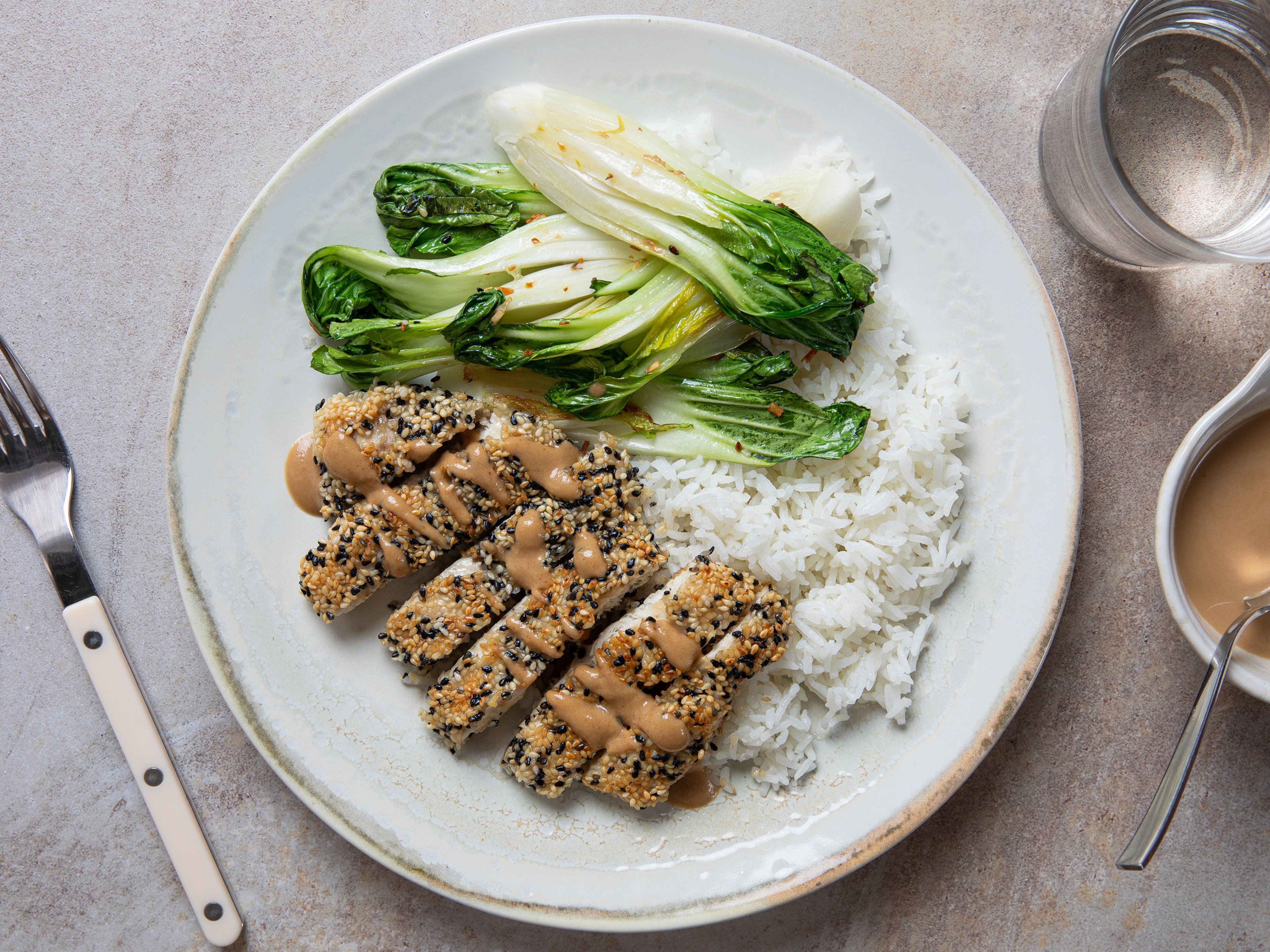 Knuspriges Sesam-Hähnchenschnitzel mit Erdnusssoße und Pak Choi