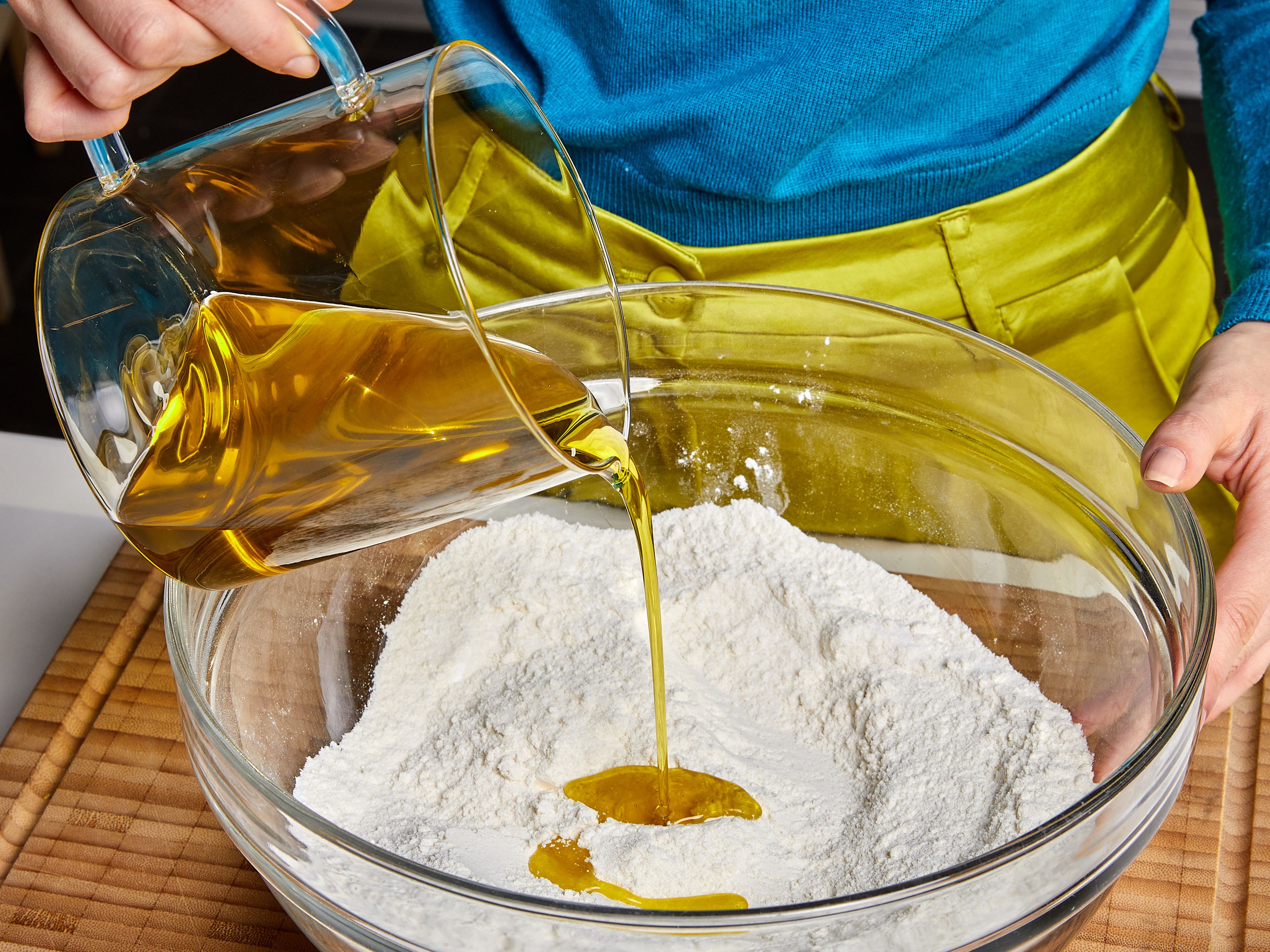 Add flour, sugar, baking powder, and salt to a large mixing bowl. Mix well. Add oat milk, extra virgin olive oil, vanilla extract, lemon juice and zest and mix well until no lump forms.