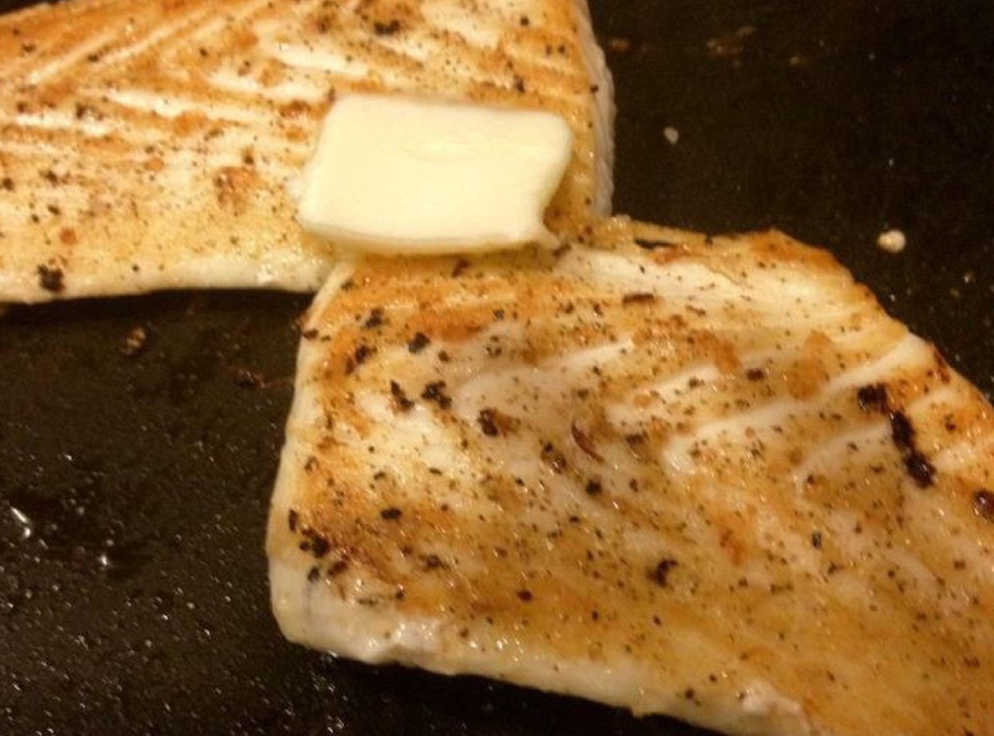 Season both sides of the fish with salt and freshly-cracked pepper. Brown both sides of the halibut in the bacon fat. Cook the first side for 4 – 5 min., then turn over. Place butter on the fish. Cook the other side for 3 – 4 min.