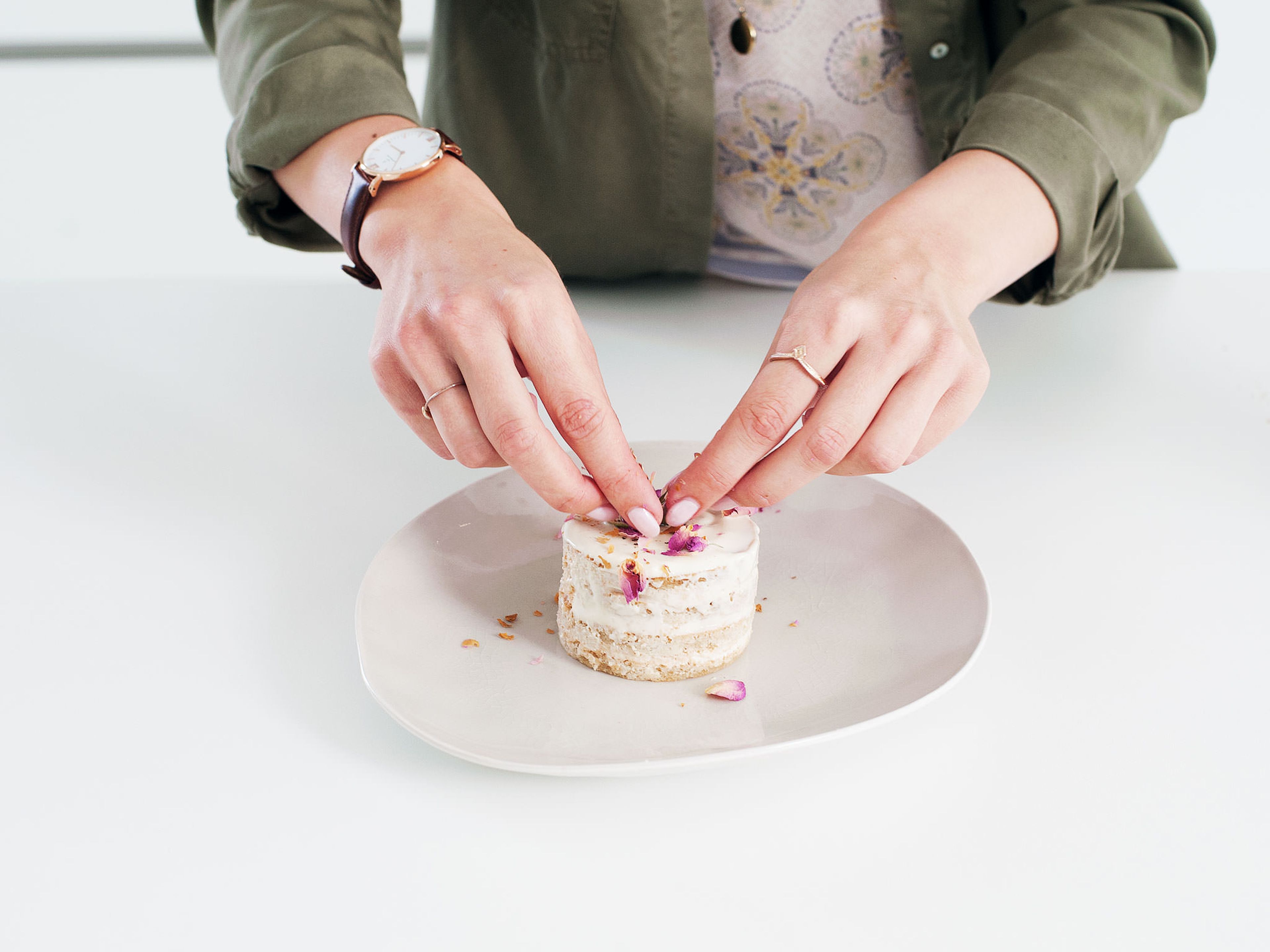 Carefully loosen the cakes from their rings, using a small knife, if needed. Spread the remaining cream on top of each cake and, if you like, on the sides of the gateaux. Top with dried rosebuds.