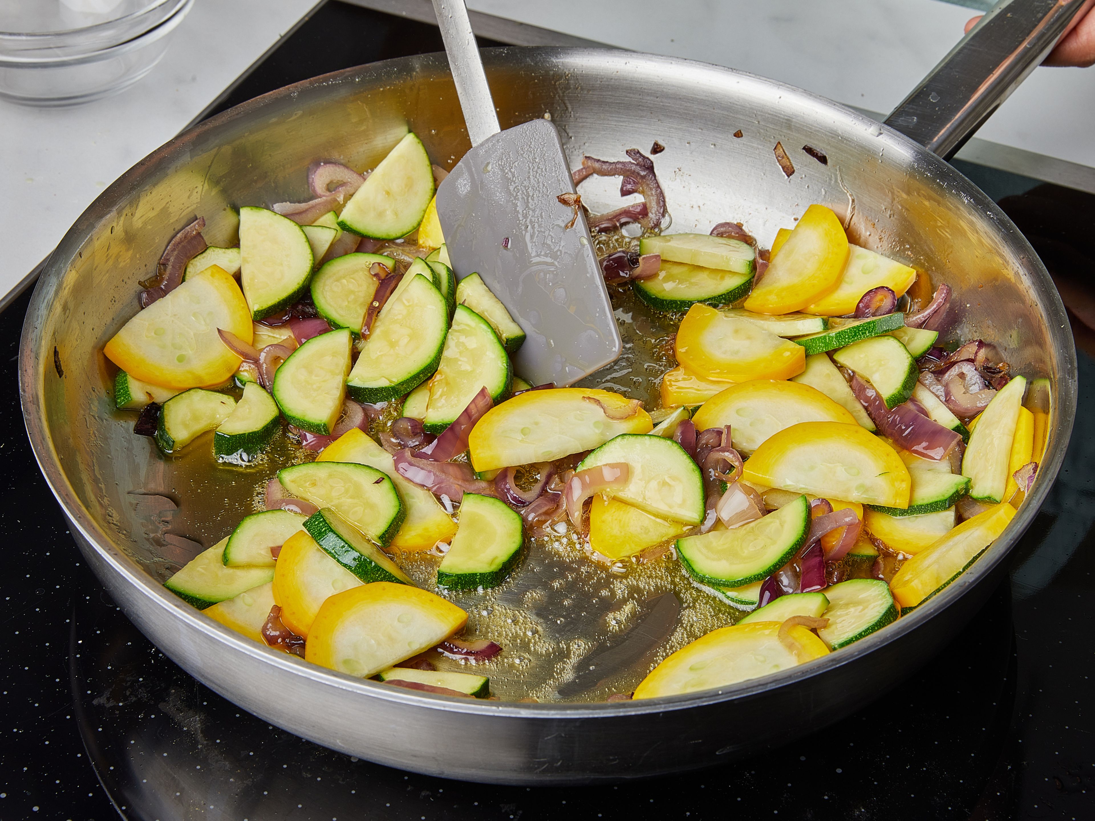 Add ⅔ of the olive oil to a big frying pan. Heat over medium heat and add onions. Season with salt and fry until soft. Add in zucchini slices, season with salt and pepper and fry until soft. You might want to increase the heat here for more char. Add the garlic towards the end of frying, remove from heat and add the zucchini mix to the pasta.