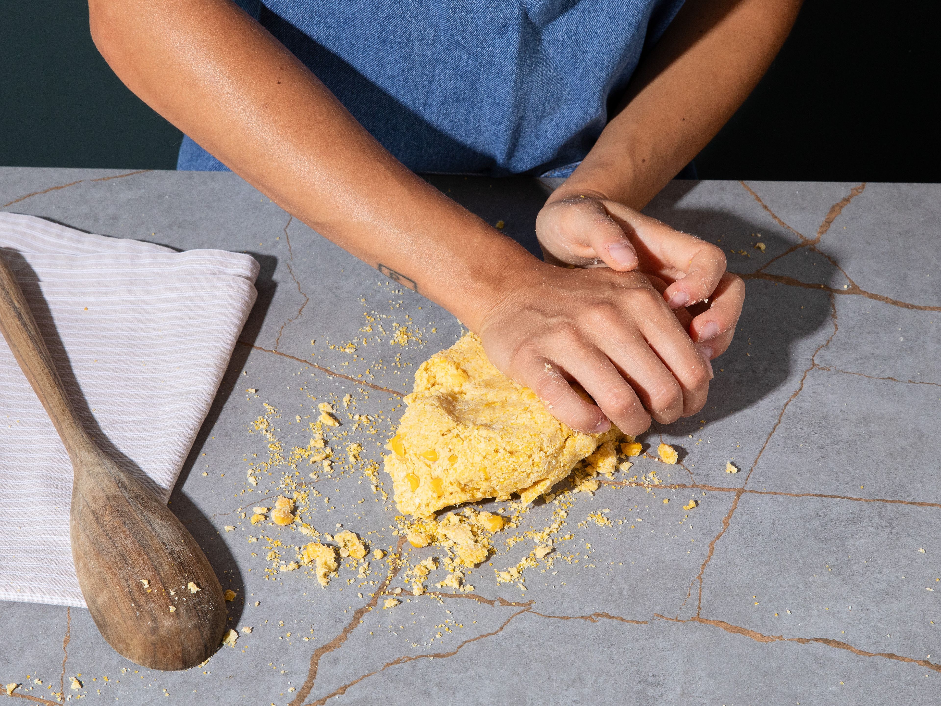 Preheat oven to 200°C/400°F top/bottom heat. Cut corn kernels from cob and puree in a blender into a coarse paste. Mix flour, polenta, baking powder, sugar, and salt in a bowl. Add corn paste, olive oil, and yogurt, and knead into a smooth dough. Cover and let rest while preparing grapes.