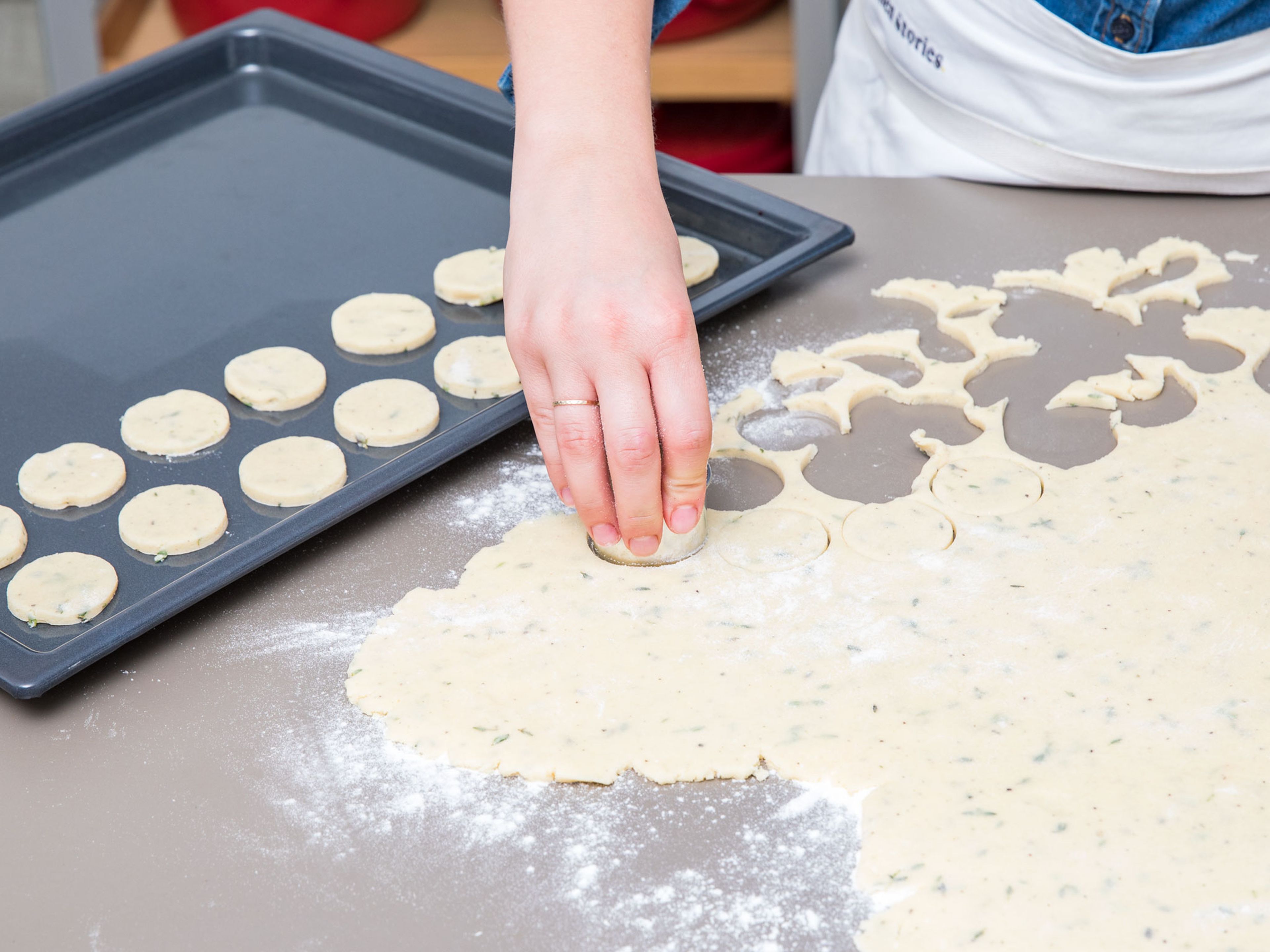 Flour a working surface and roll out the cooled dough, approx. 0.5-cm/0.2-in. thick. Use a cookie cutter to cut out circles to desired size. Transfer them onto a parchment-lined baking sheet.