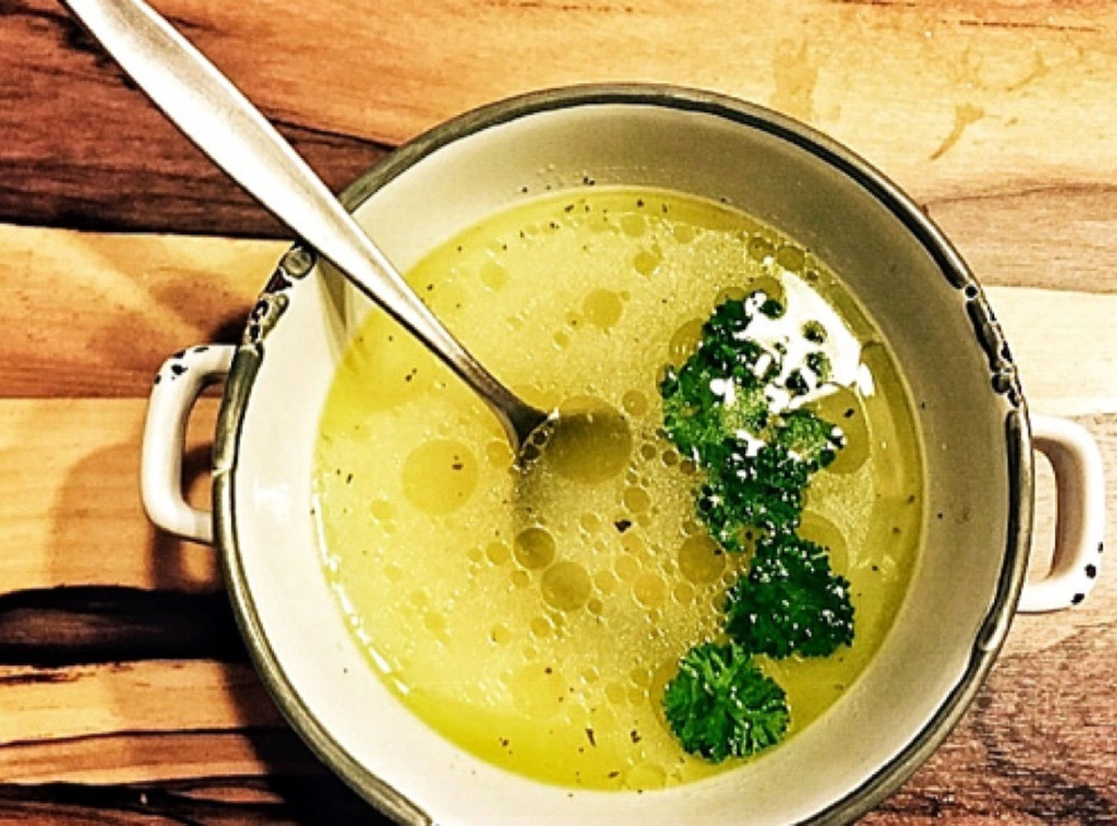 Serve clear broth in a bowl and garnish with parsley.