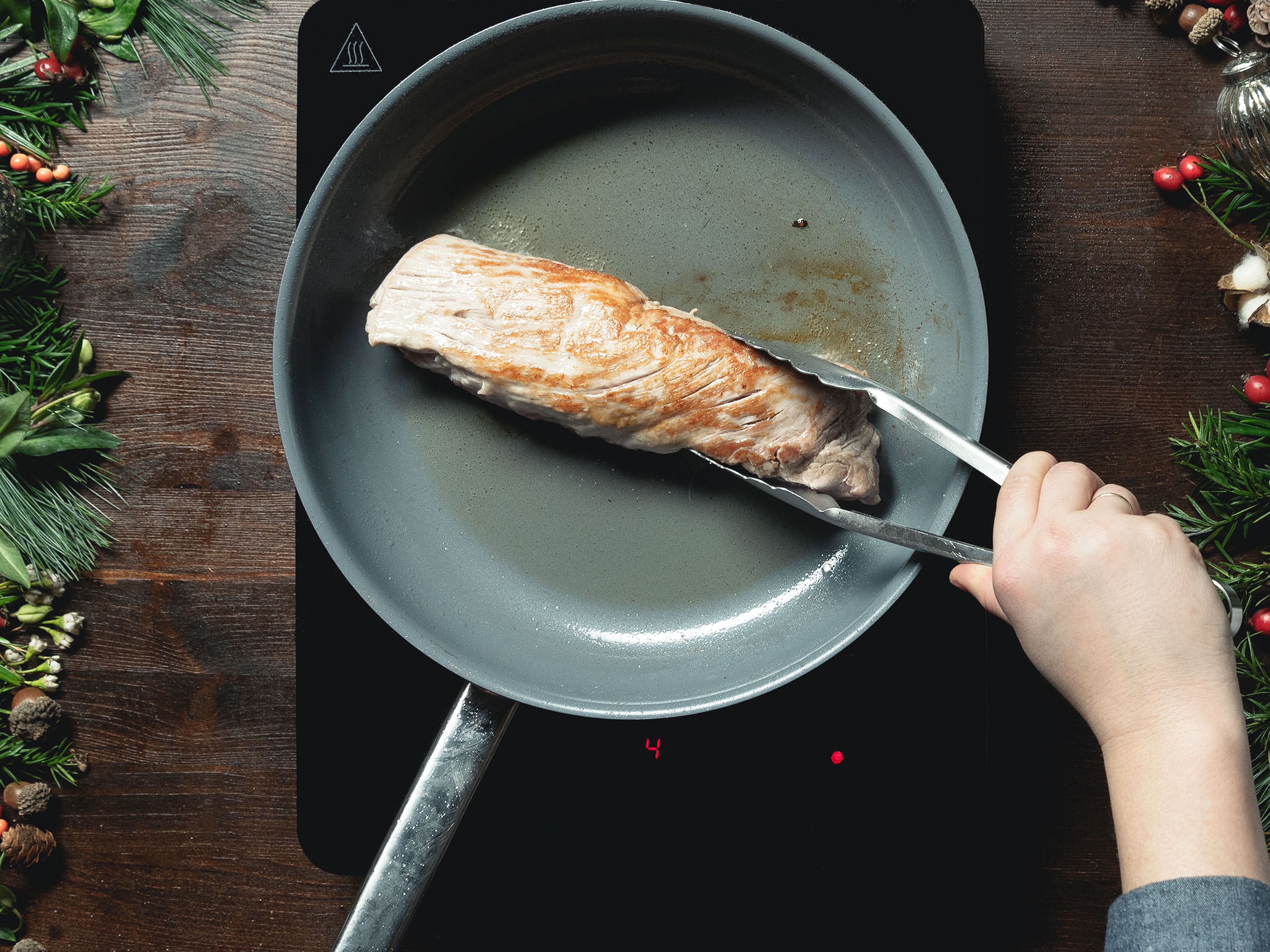 Add some vegetable oil to a frying pan over medium-high heat. Sear the pork until golden brown on both sides and season with salt.