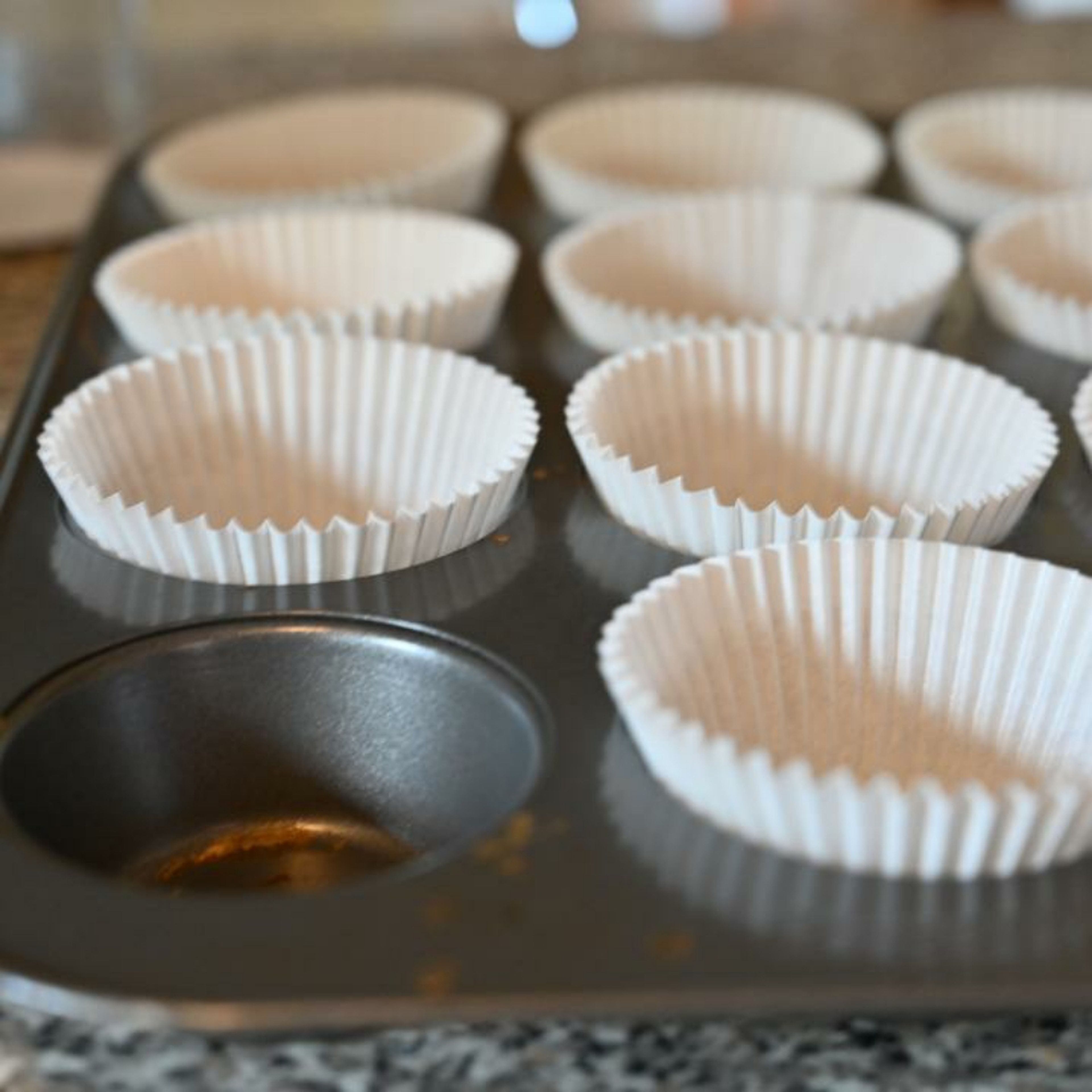 Line the cupcake tray with cupcake cases.