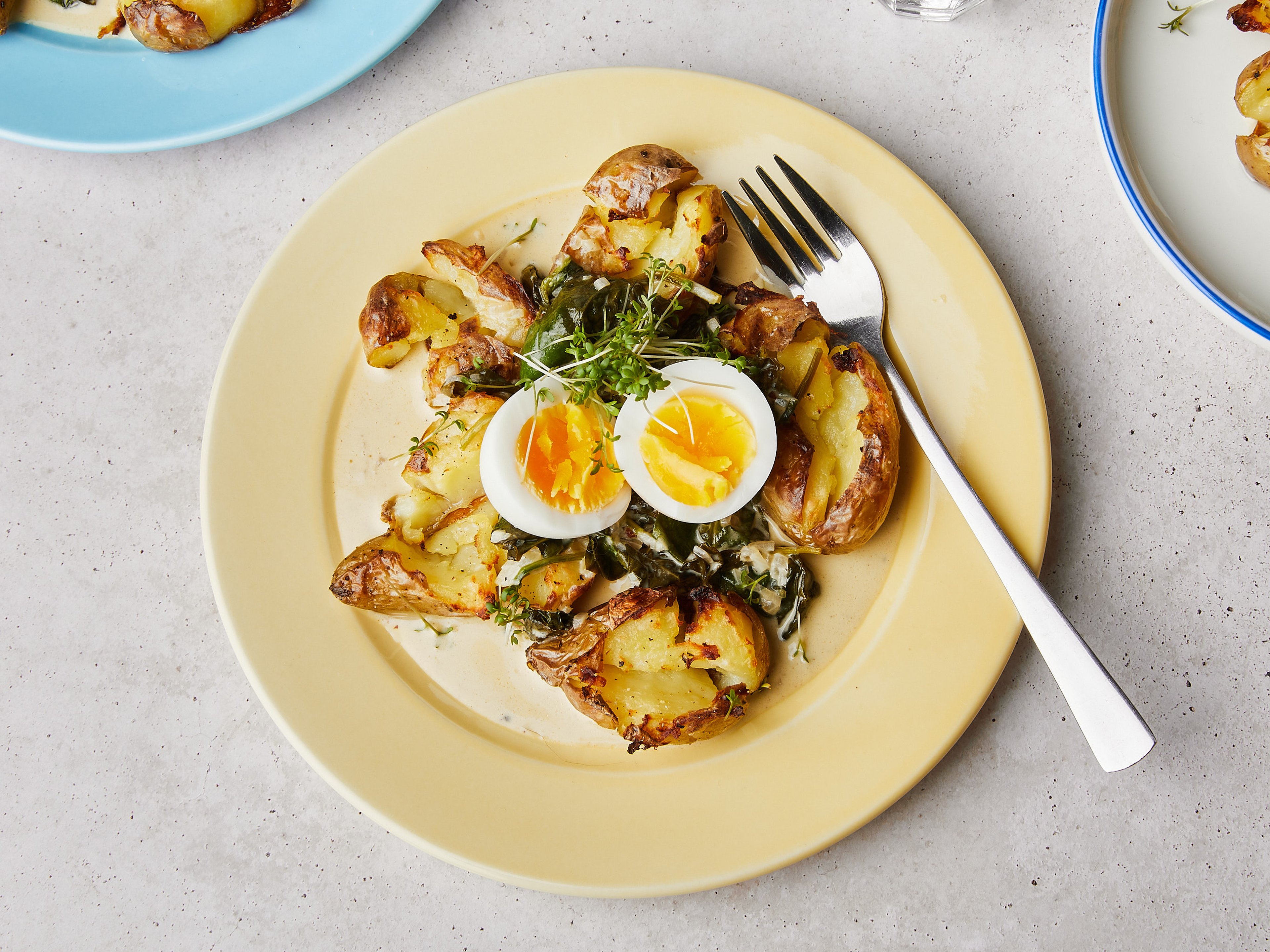 Crispy smashed potatoes with creamed spinach