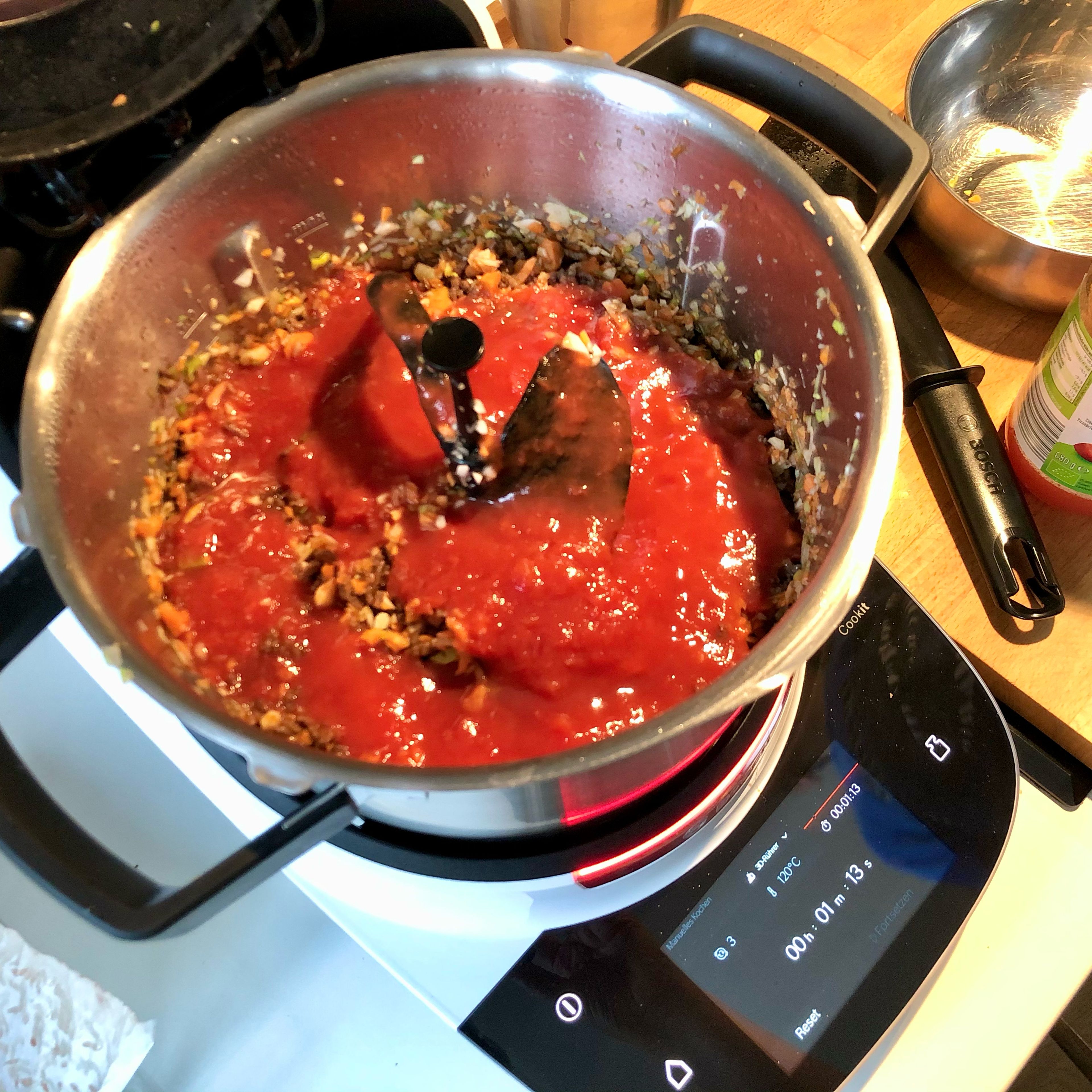 Den 3D-Rührer und den Topfdeckel einsetzen, ohne Messbecher. Gemüsewürfel und passierte Tomaten zugeben und bei geschlossenem Deckel (ohne Messbecher) köcheln lassen (3D-Rührer | Stufe 3 | 100°C | 30 Min.). Nach etwa 4 Minuten die Konsistenz kontrollieren: So viel Brühe zugießen, dass die Flüssigkeit sichtbar ist, die Bolognese aber nicht zu suppig wird. Nach etwa 30 Minuten ist die Bolognese fertig. Der Cookit hält sie anschließend auch warm, falls die Familie nicht so schnell am Tisch sitzt.