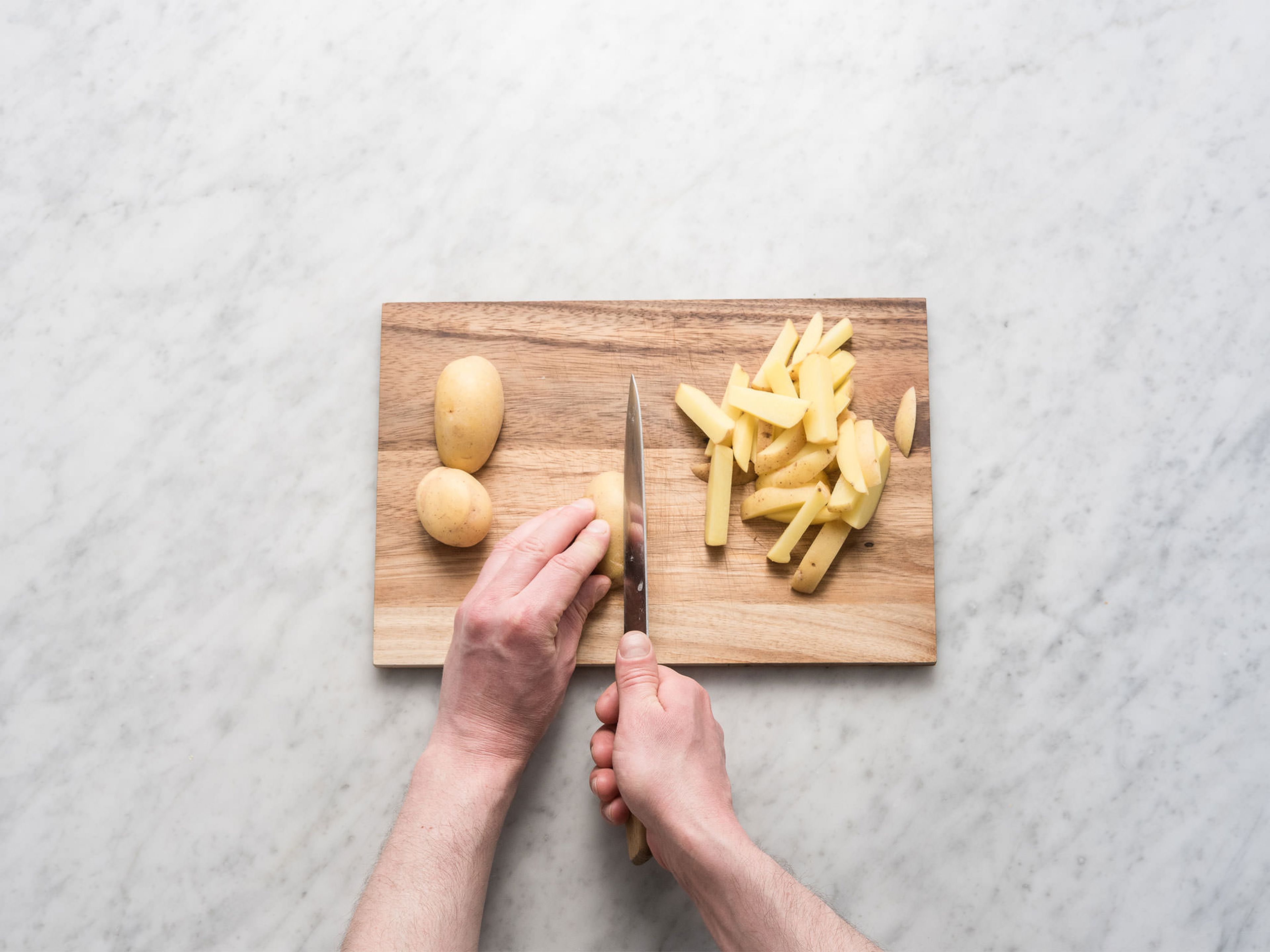 Preheat oven to 200°C/390°F. Cut potatoes into thin, French fry-shaped strips. In a large bowl, toss with olive oil, curry powder, ground nutmeg, and smoked salt. Transfer to a parchment paper-lined baking sheet and bake in preheated oven, turning occasionally, at 200°C/390°F for approx. 25 – 30 min. until crispy and golden.