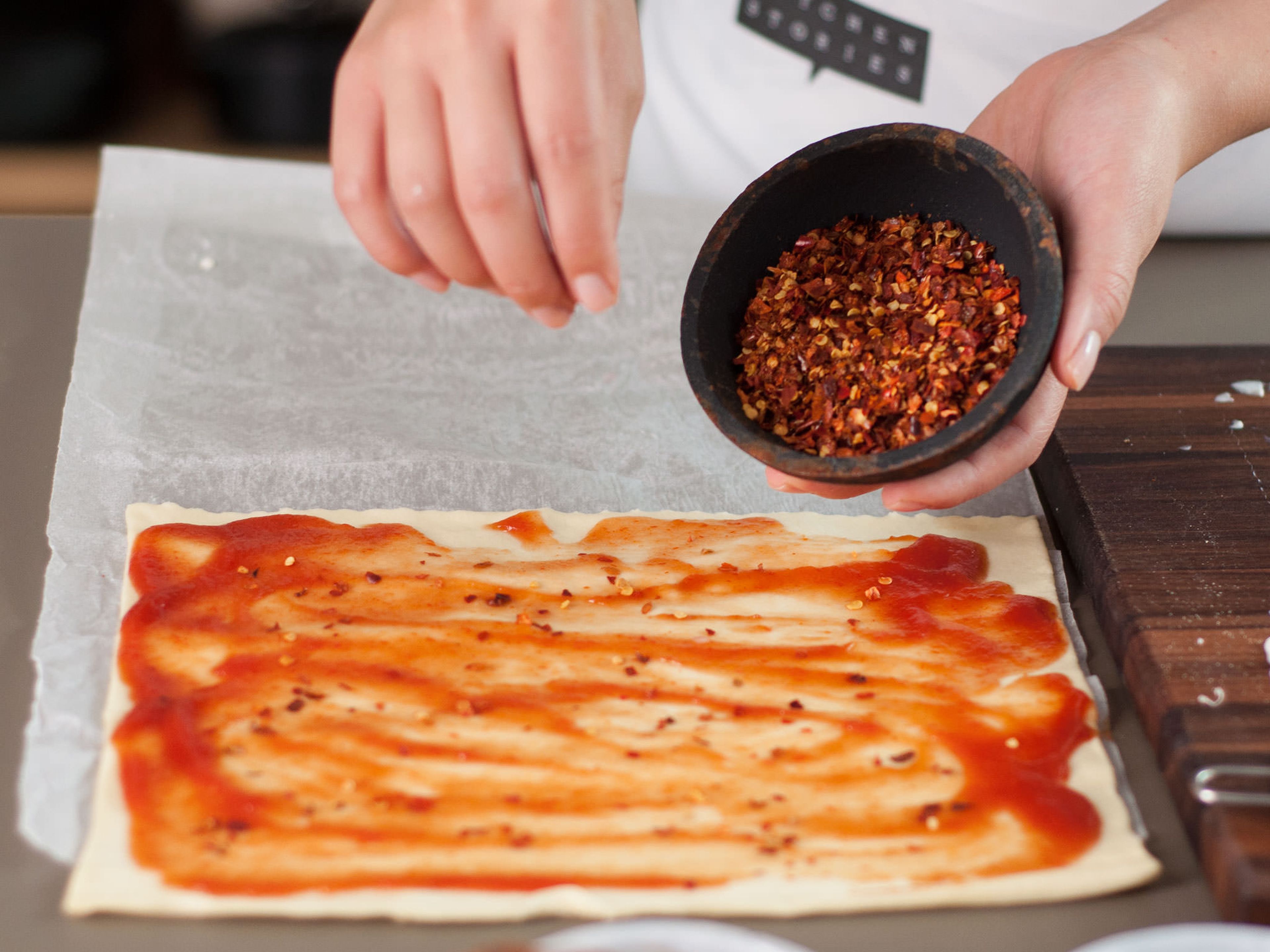 Spread ketchup over other half of the puff pastry. Sprinkle chili flakes on top.