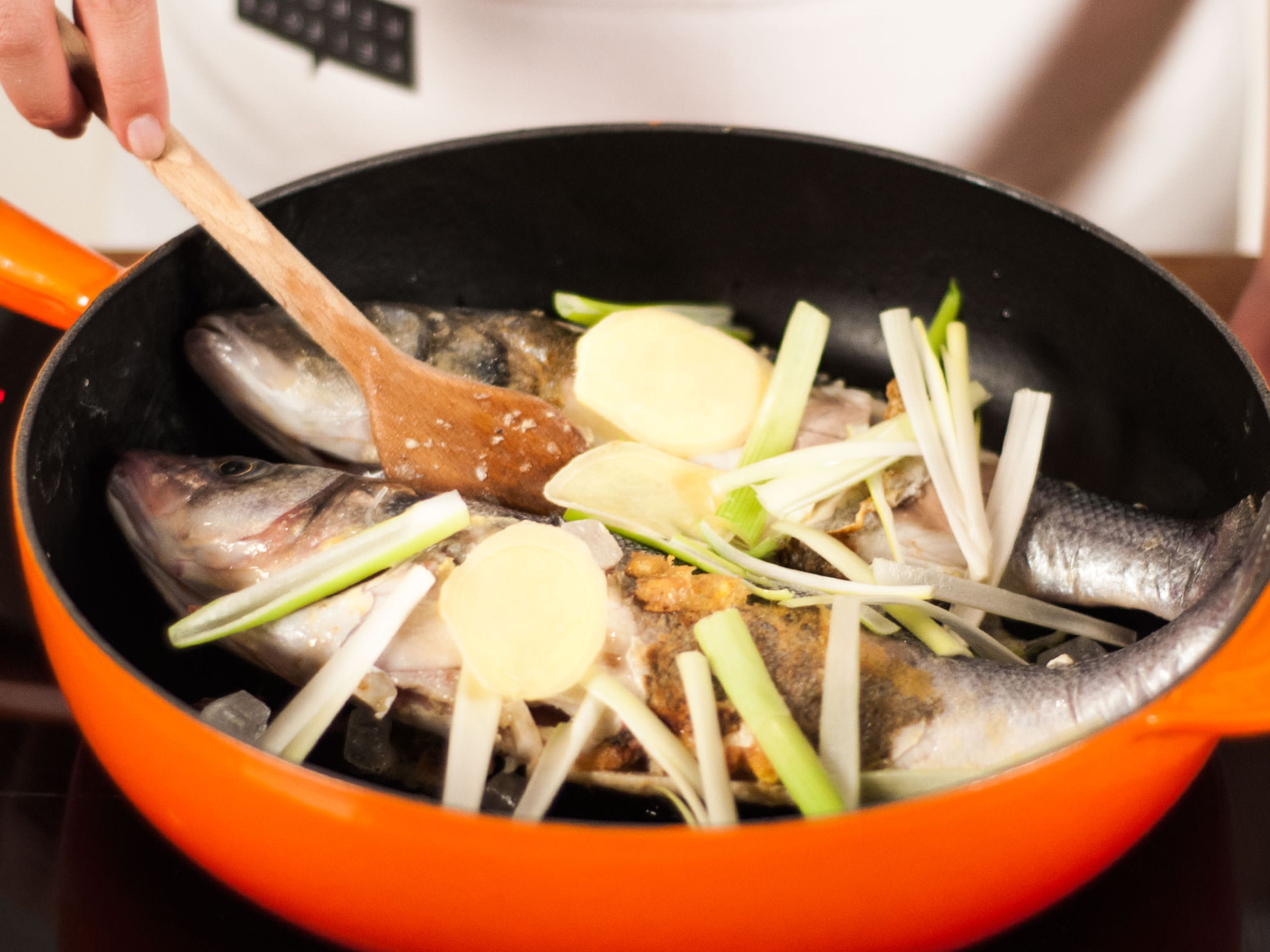 Add sliced ginger, spring onion, garlic, star anise, and rock sugar to the pan and continue to fry for approx. 1 – 2 min.