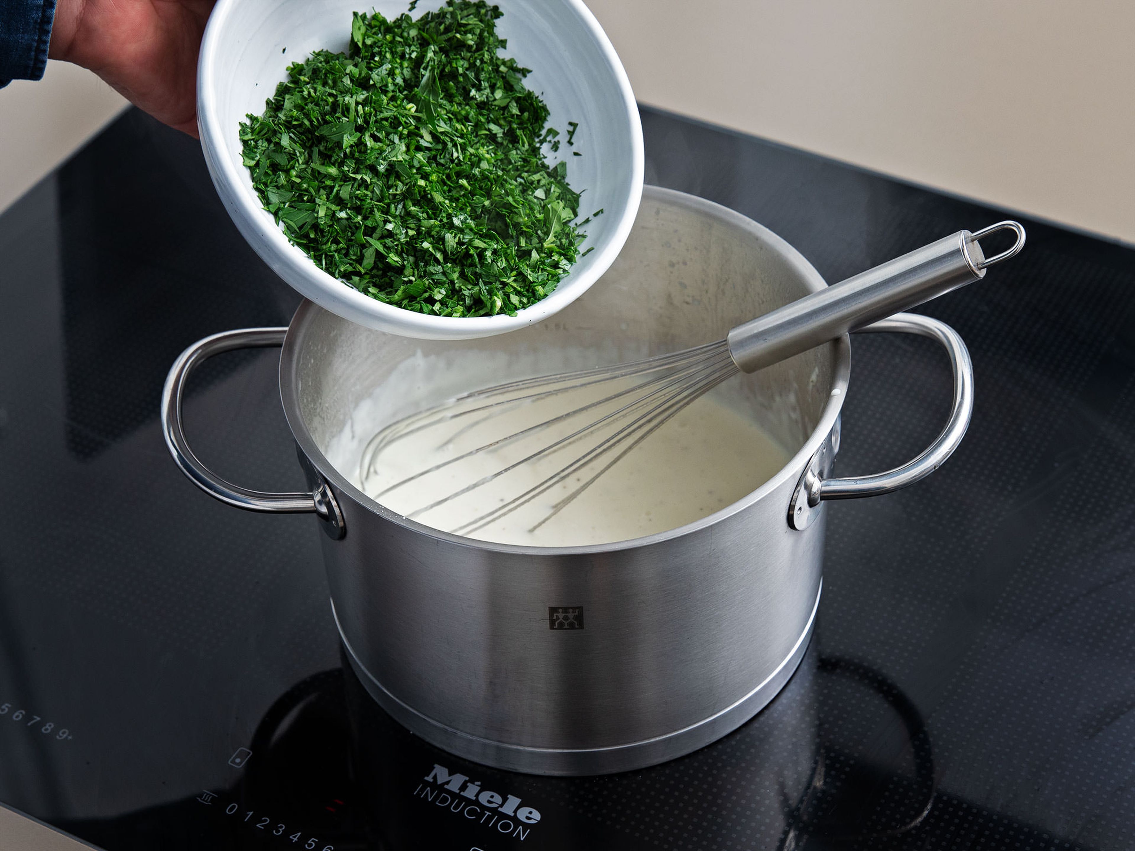 Meanwhile, melt butter in a pot over medium heat and whisk in the flour, until you get a smooth roux. Gradually whisk in the milk, season with salt and pepper, and add cream. Once thick and smooth, add parsley.