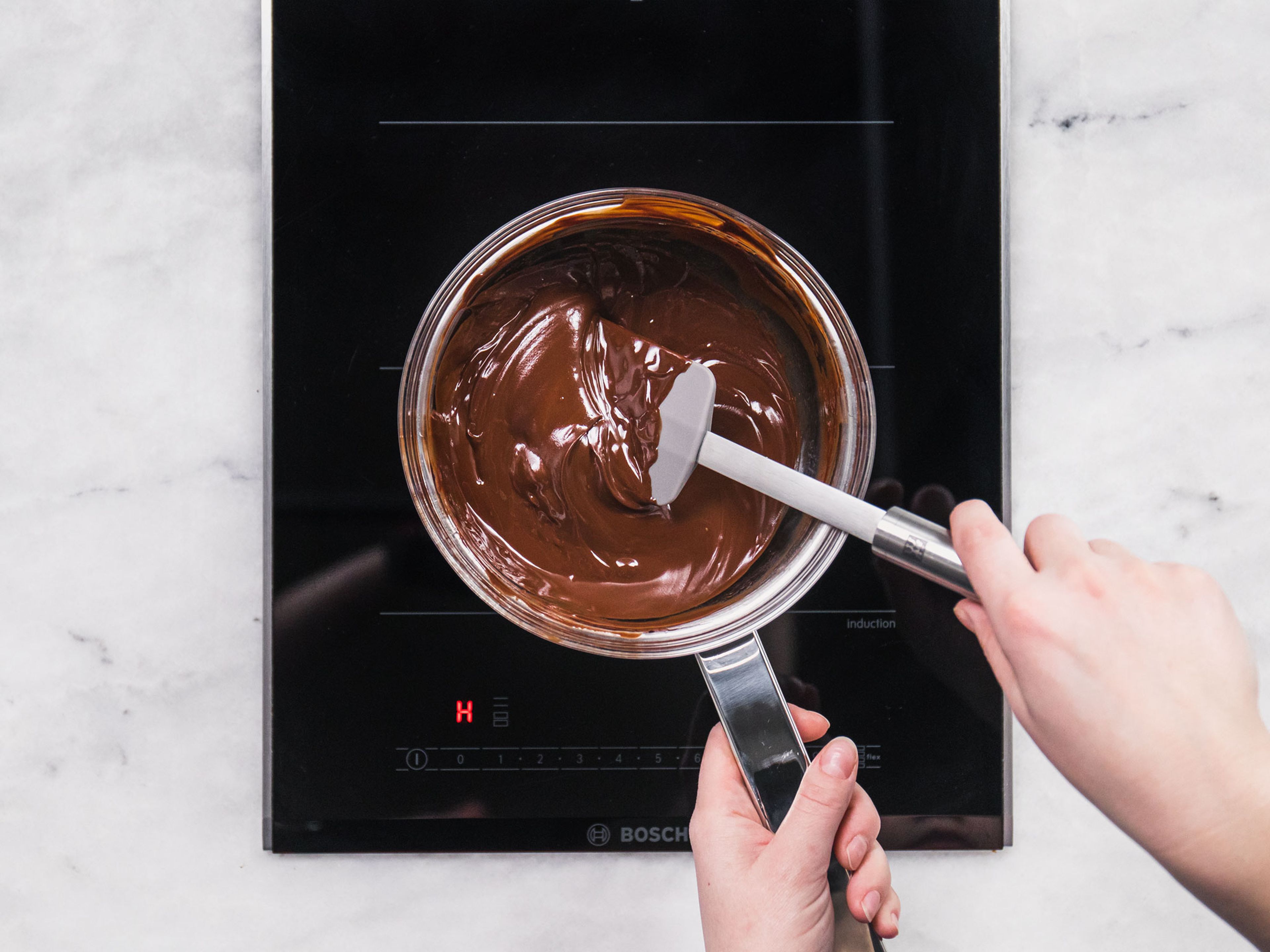 Add some water to a saucepan and bring to a simmer. Place a heatproof bowl on top of the saucepan, making sure it doesn’t touch the simmering water underneath. Add chocolate and butter to the bowl, allow to melt, stirring occasionally, then remove from the heat and set aside.