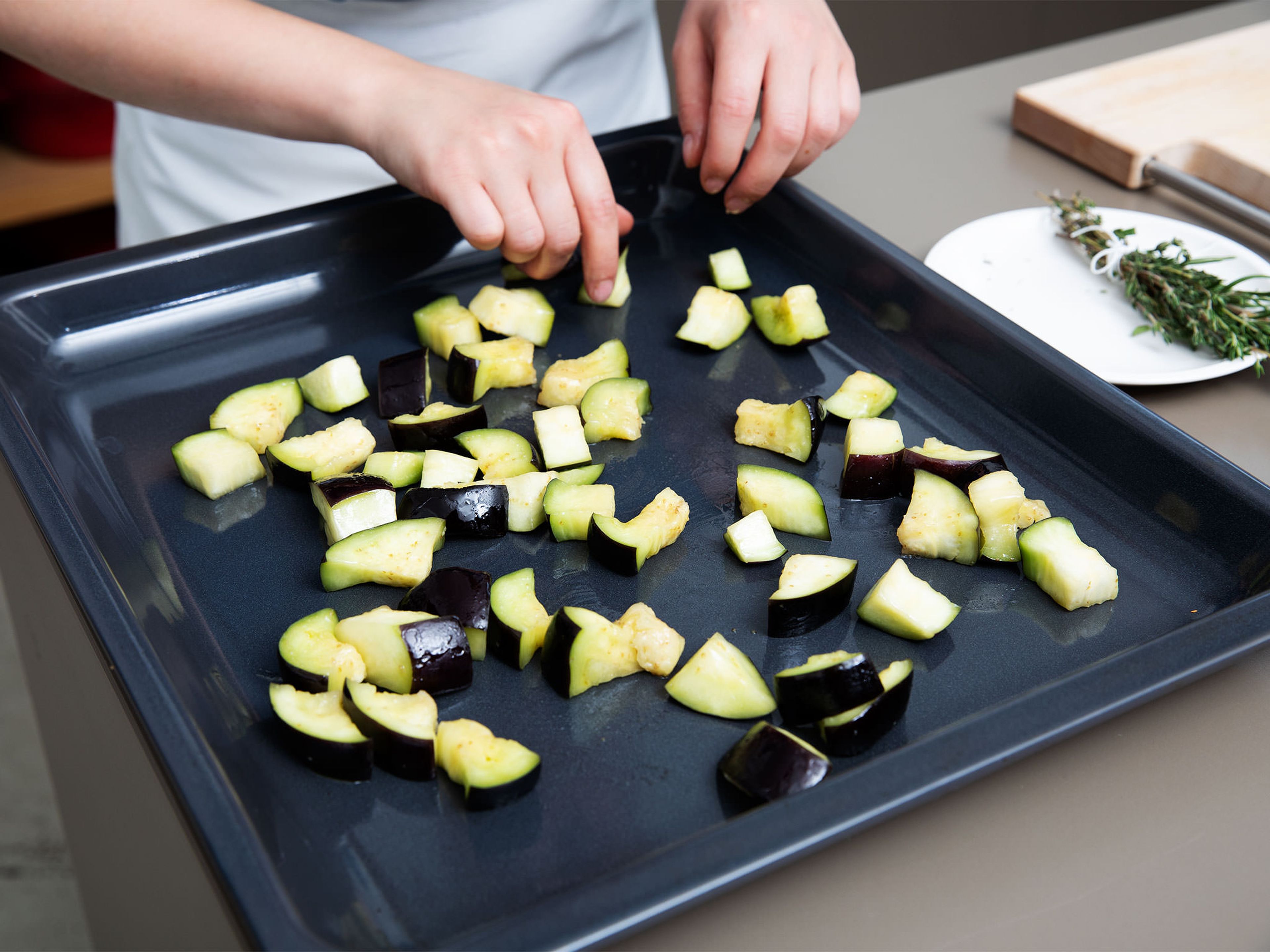 Squeeze out excess water from the eggplant, massage it with a part of the olive oil and spread out onto a parchment-lined baking sheet. Transfer to the oven and let roast for approx. 20 min. at 200°C/390°F.