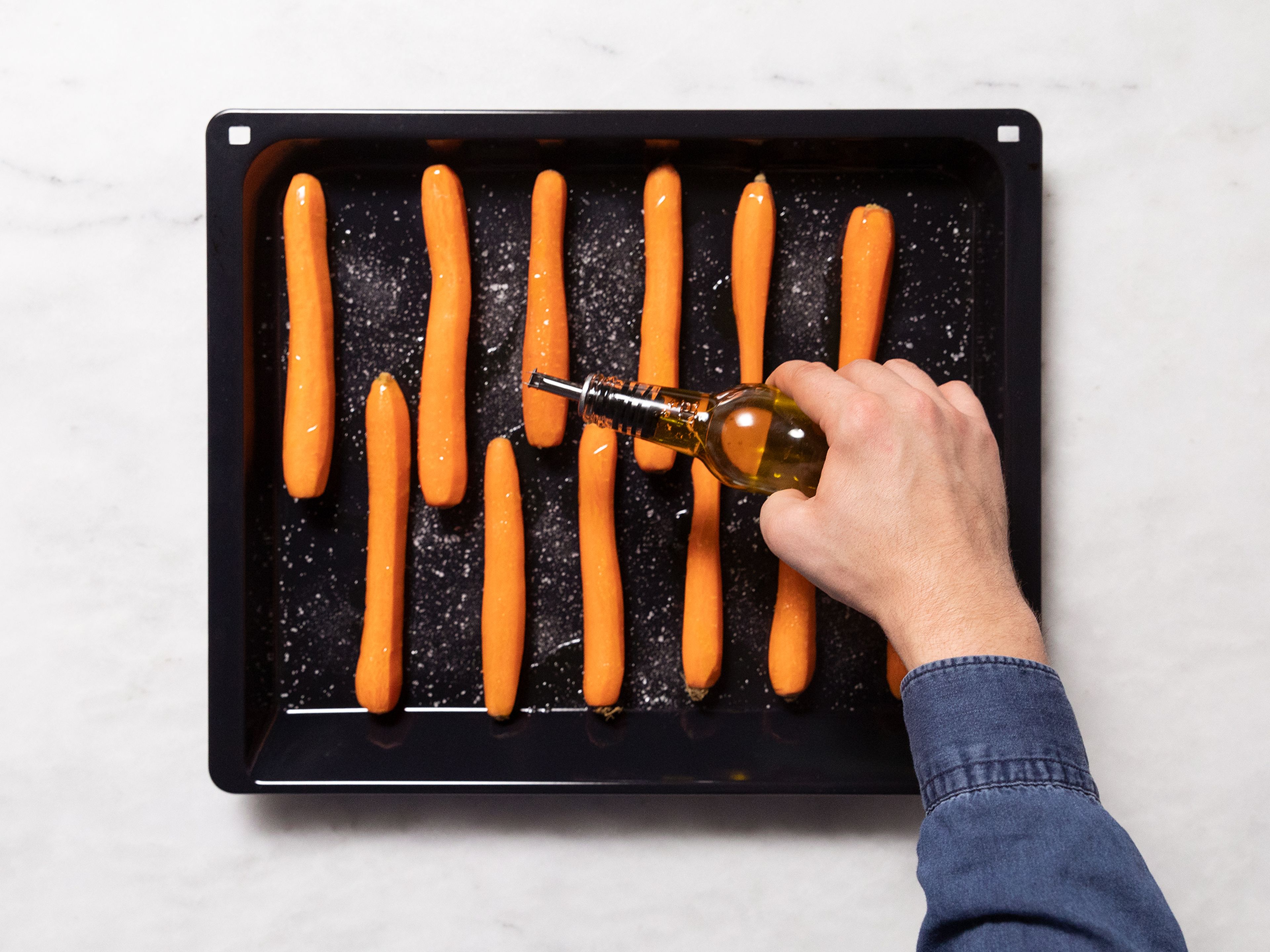 Preheat the oven at 180°C/350°F. Peel carrots and transfer onto a baking sheet. Drizzle with some olive oil, season with salt, and roast for approx. 45 min.